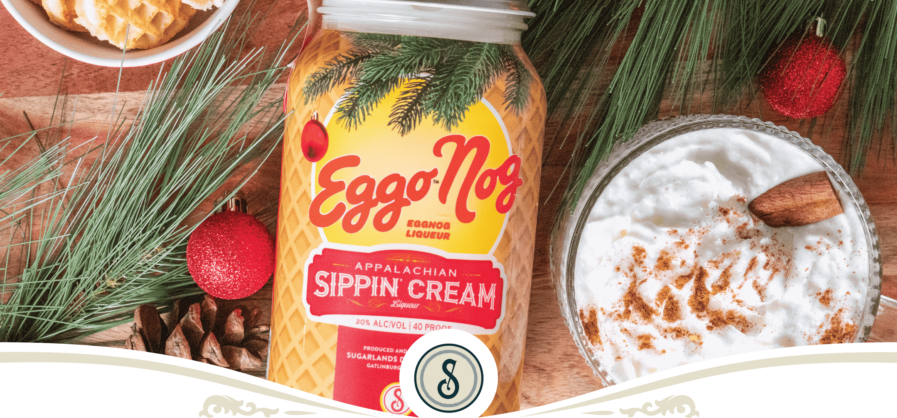 Eggo Nog Appalachian Sippin' Cream bottle with holiday decorations and whipped cream, perfect for festive celebrations.