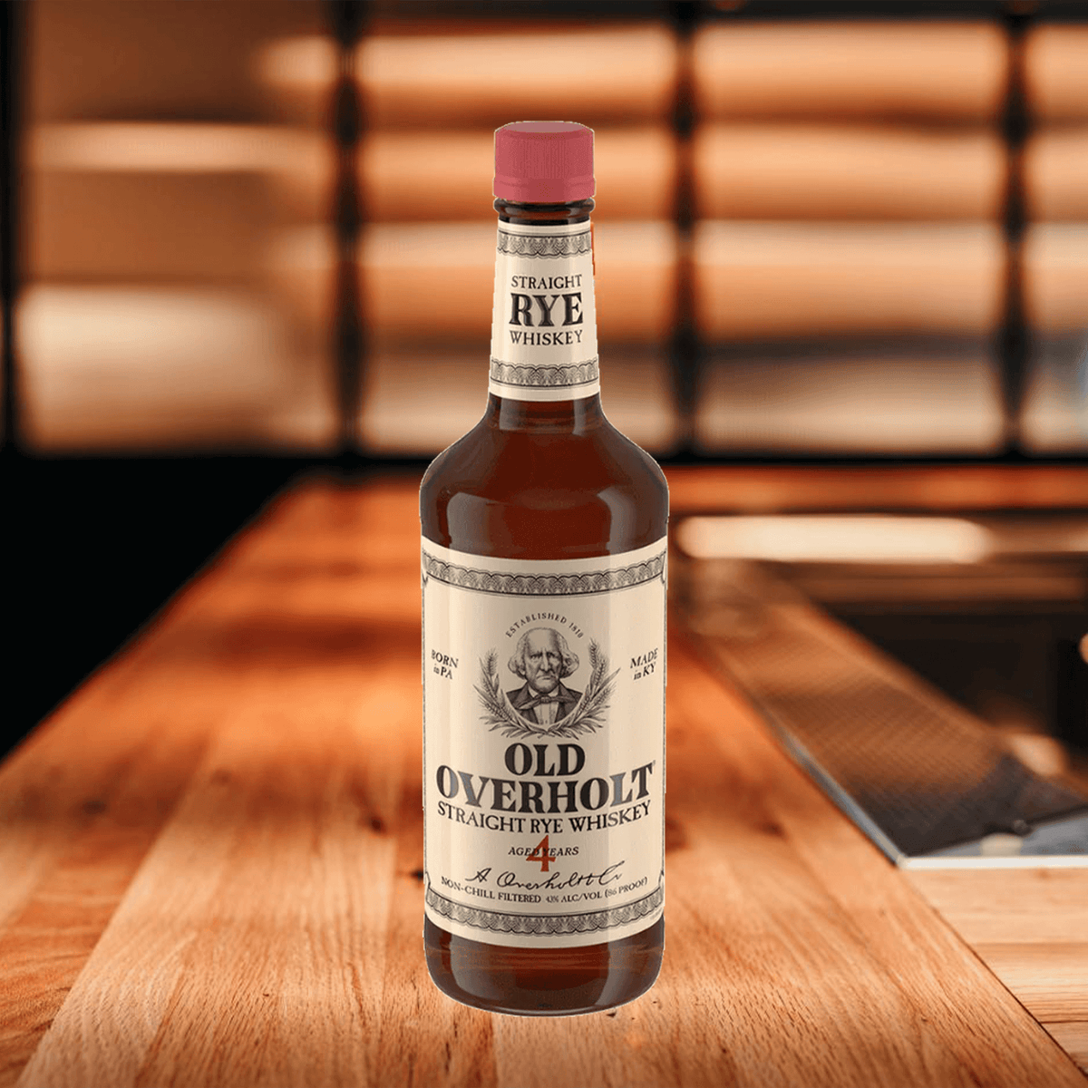Old Overholt 4 Year Straight Rye Whiskey bottle on wooden countertop with warm lighting