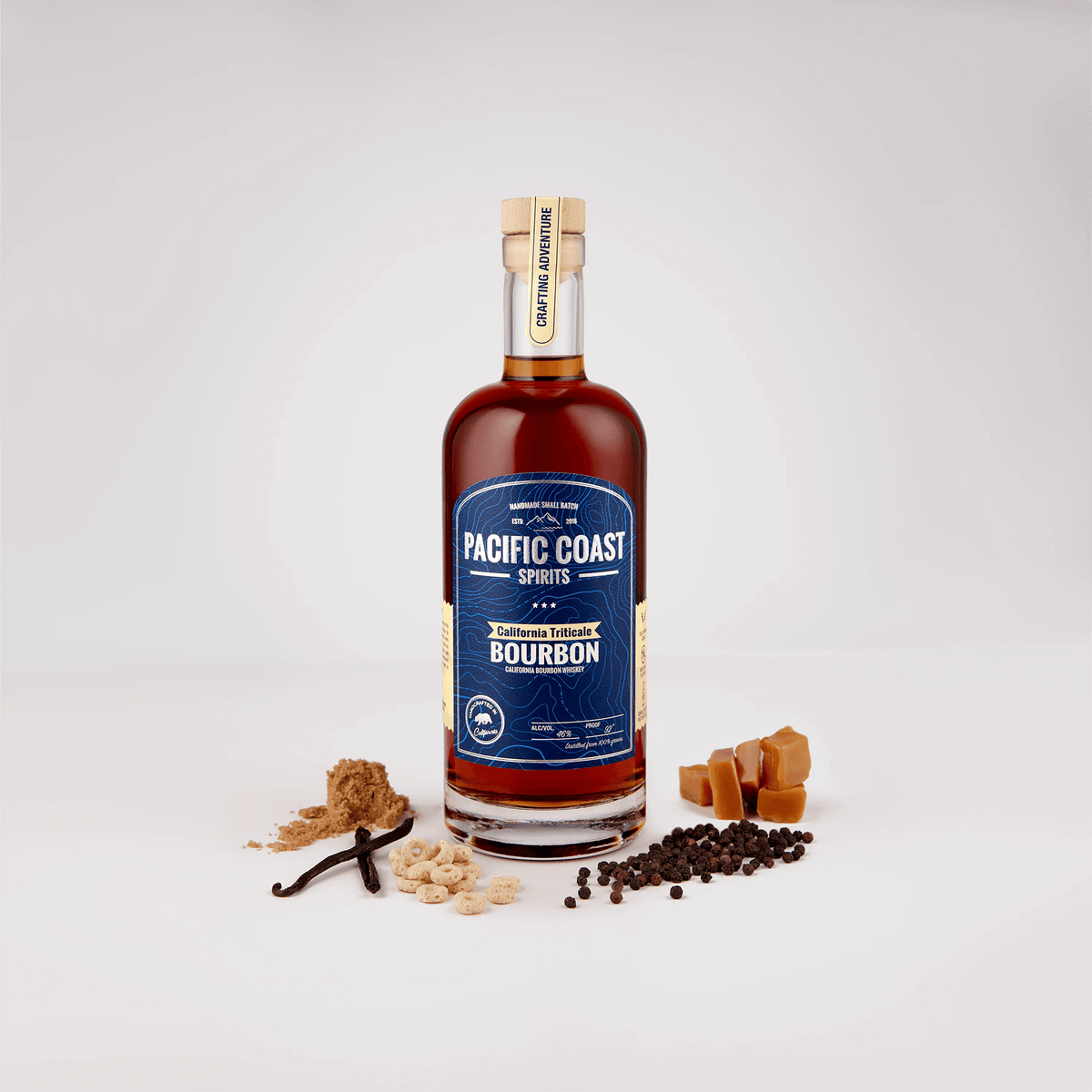Bottle of Pacific Coast Triticale Bourbon Whiskey with tasting notes and ingredients around it.