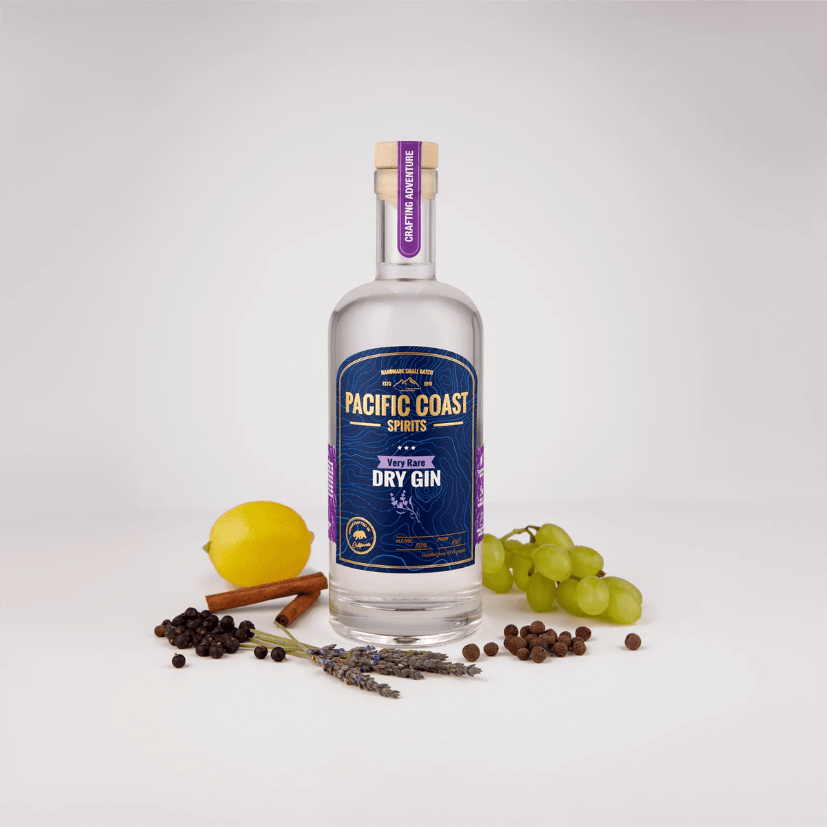 Bottle of Pacific Coast Very Rare Dry Gin surrounded by botanicals like lemon, lavender, and grapes.
