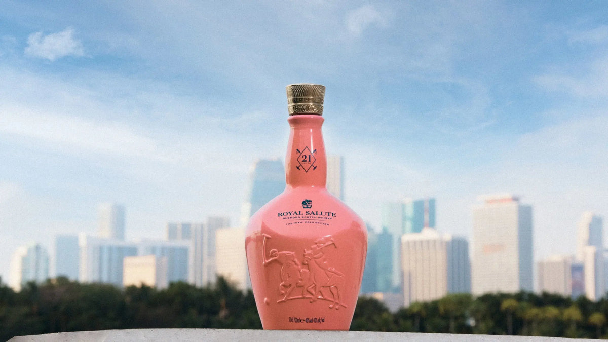 Royal Salute The Miami Polo Edition 21 Year Blended Scotch Whisky bottle against a vibrant Miami skyline.