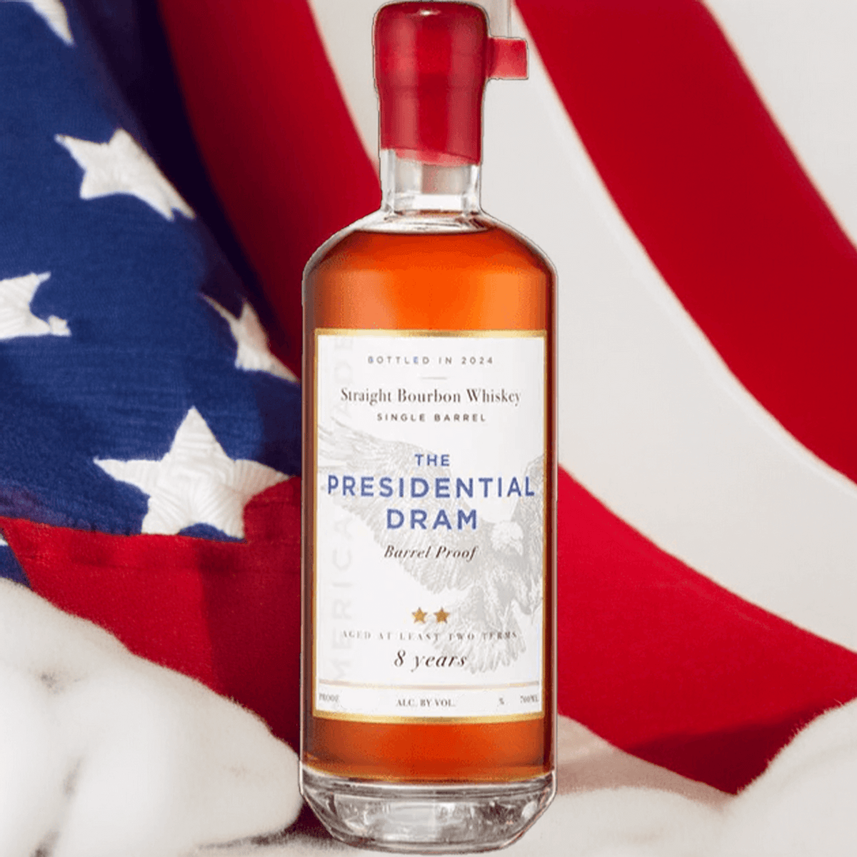 Proof & Wood The Presidential Dram 8 Year Bourbon whiskey bottle against a backdrop of an American flag.
