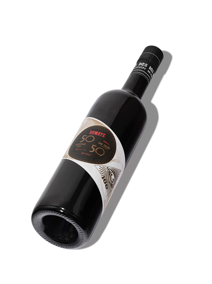Bottle of Ron Colón Salvadoreño 50/50 rum on a white background showcasing the label and sleek design.