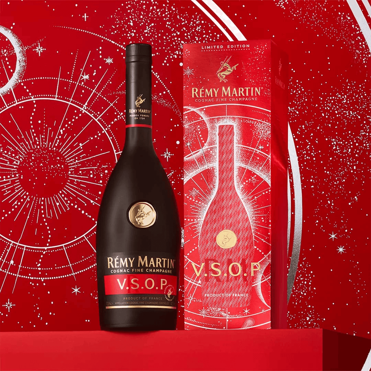 Rémy Martin VSOP Cognac bottle with limited edition box featuring astrological motifs on a red background.