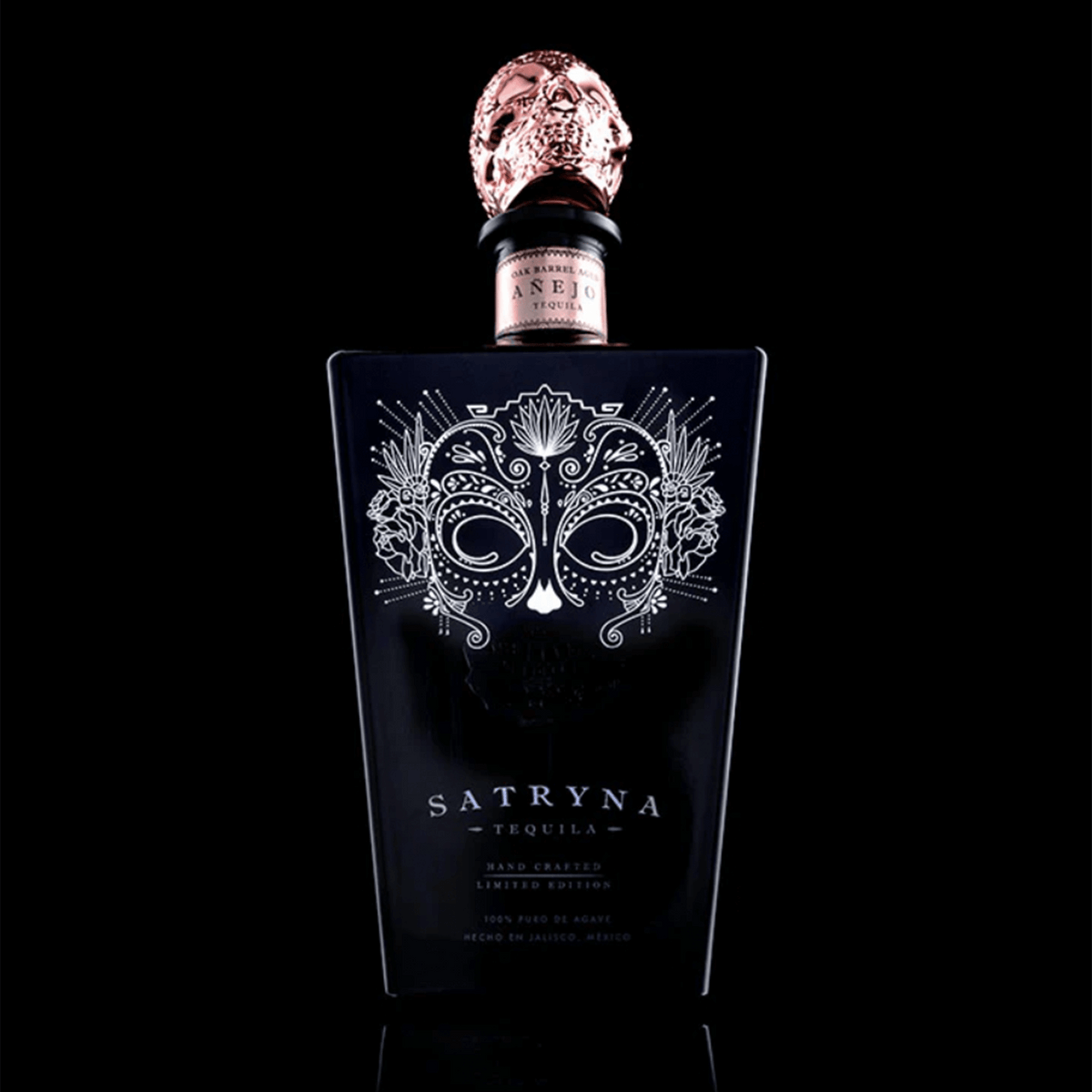Satryna Añejo Tequila bottle featuring intricate design and distinctive skull cap, handcrafted from premium agave.