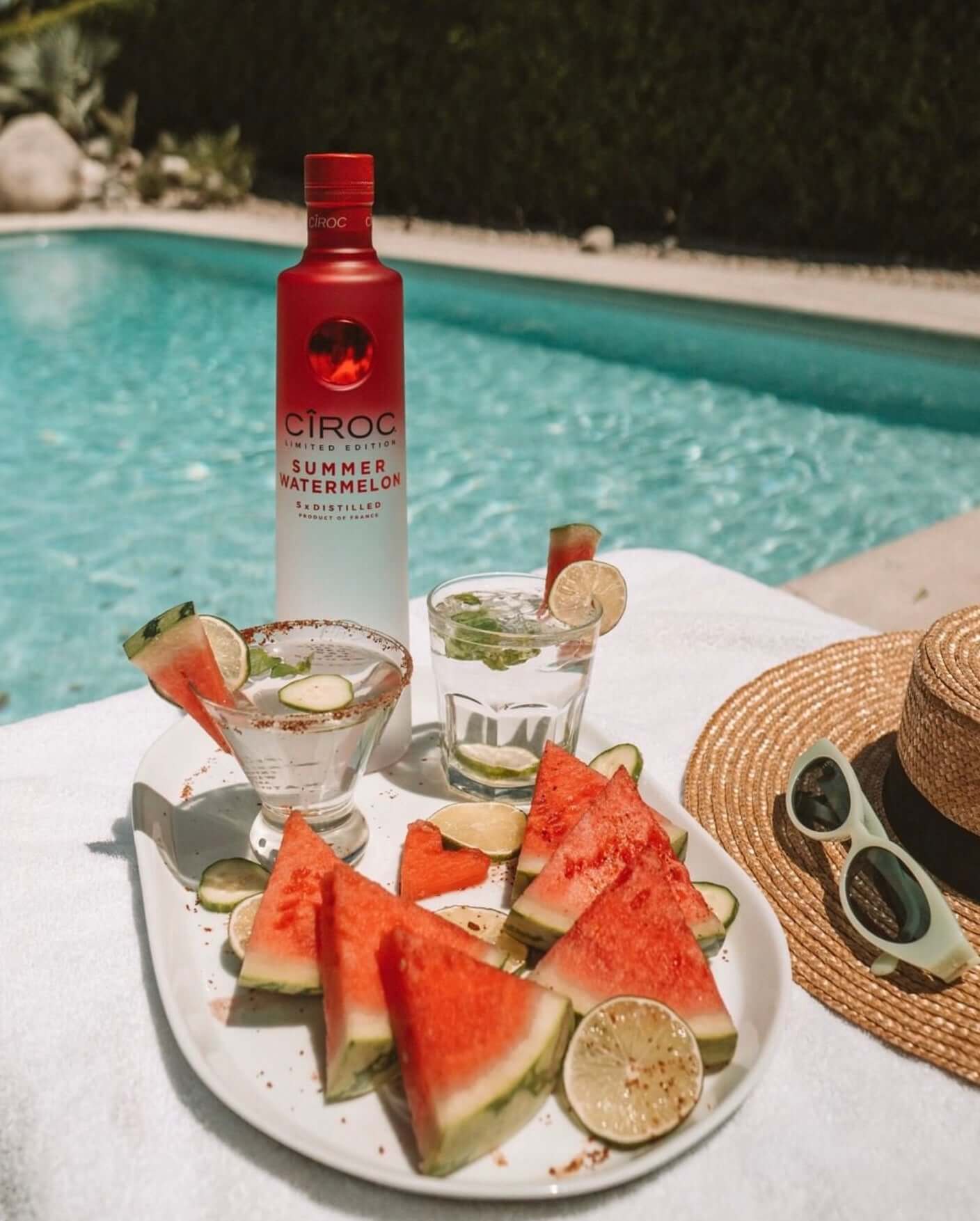 Ciroc Summer Watermelon vodka with watermelon slices and cocktails by a pool, perfect for summer refreshment.