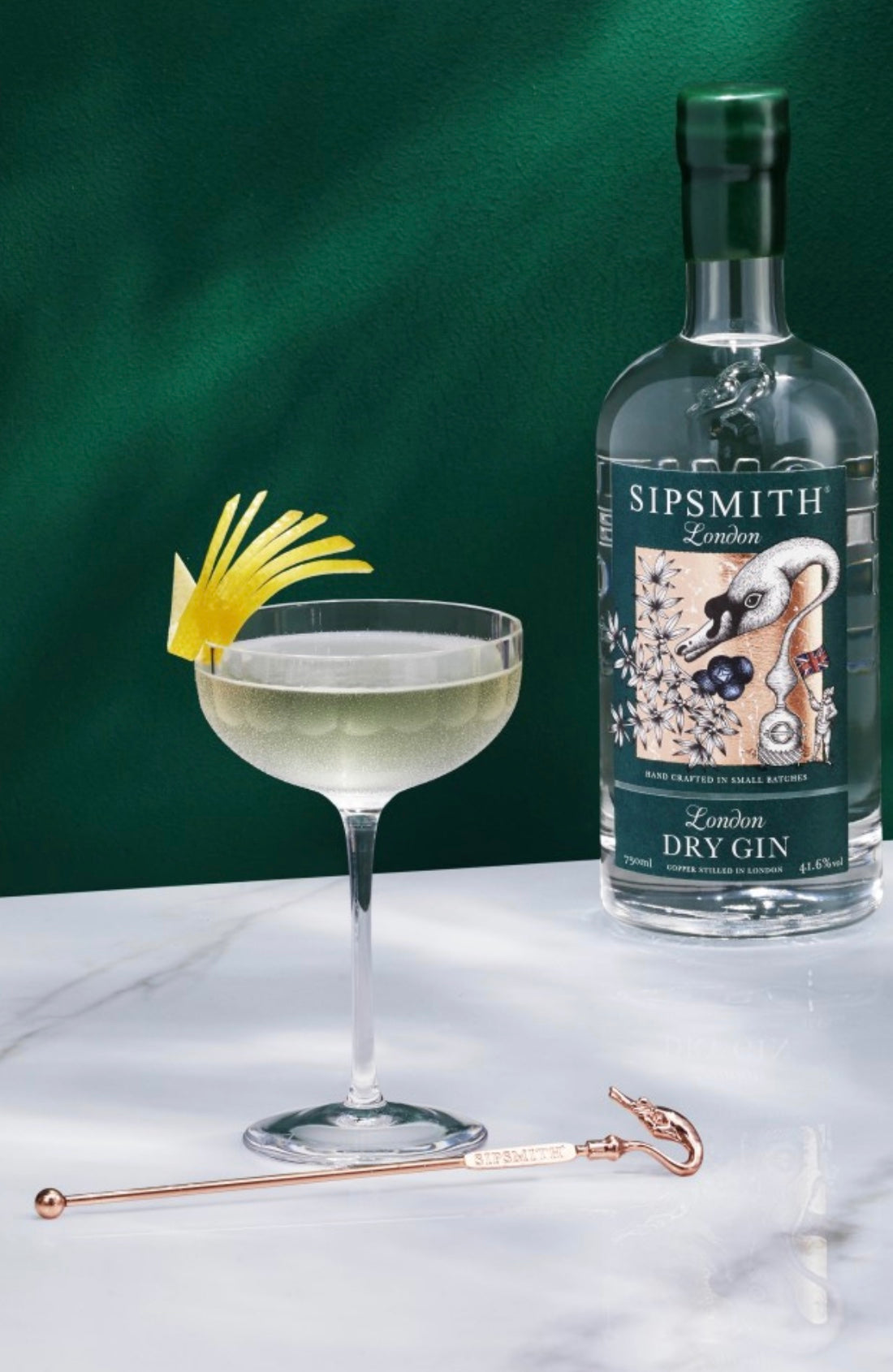 Sipsmith London Dry Gin bottle with a crafted cocktail garnished with lemon twist on a marble surface.
