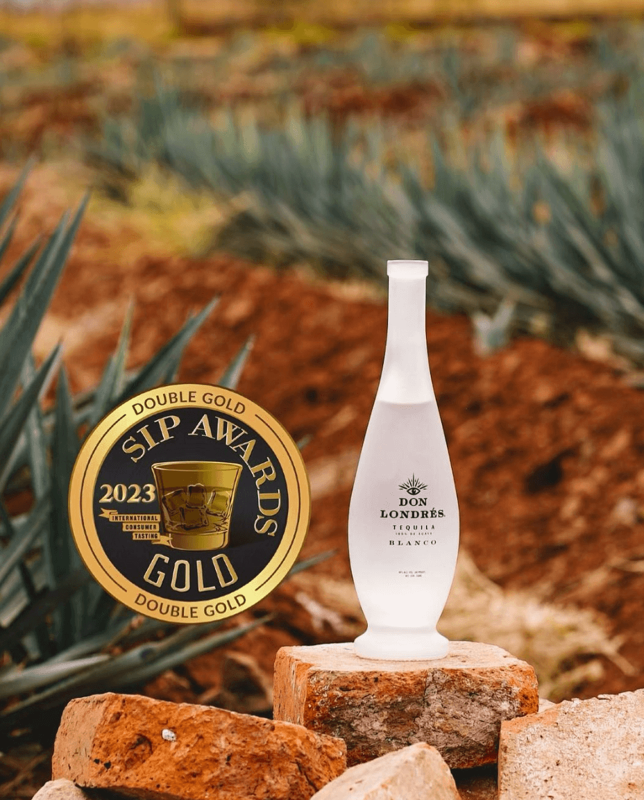 Don Londrés Blanco Tequila bottle with 2023 Double Gold Sip Awards seal on a rustic background.