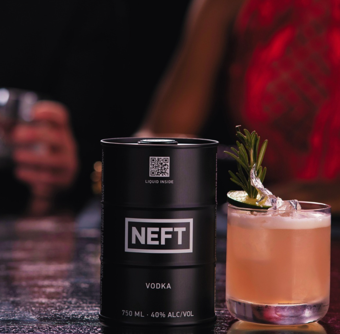 NEFT Black Barrel Australian Vodka can next to a cocktail with herbs, showcasing premium quality and minimalist design.