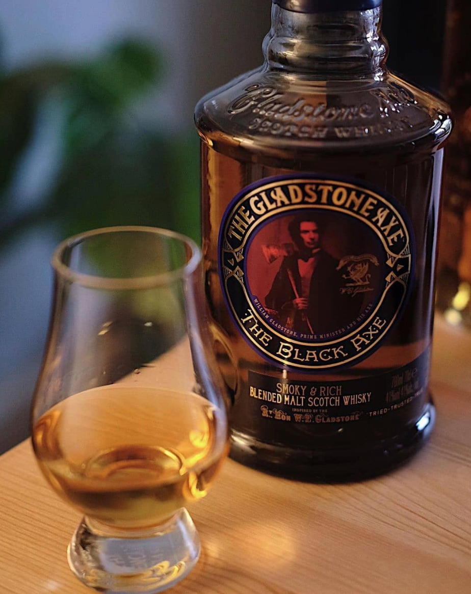 The Gladstone Axe The Black Axe blended malt Scotch whisky bottle with a tasting glass, rich smoky flavor.