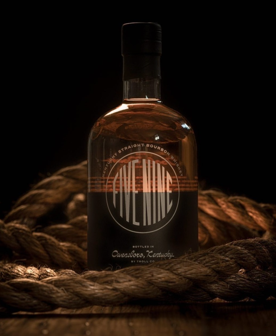 Five Nine Kentucky Straight Bourbon Whiskey bottle with a dark background and rope, showcasing craftsmanship and heritage.