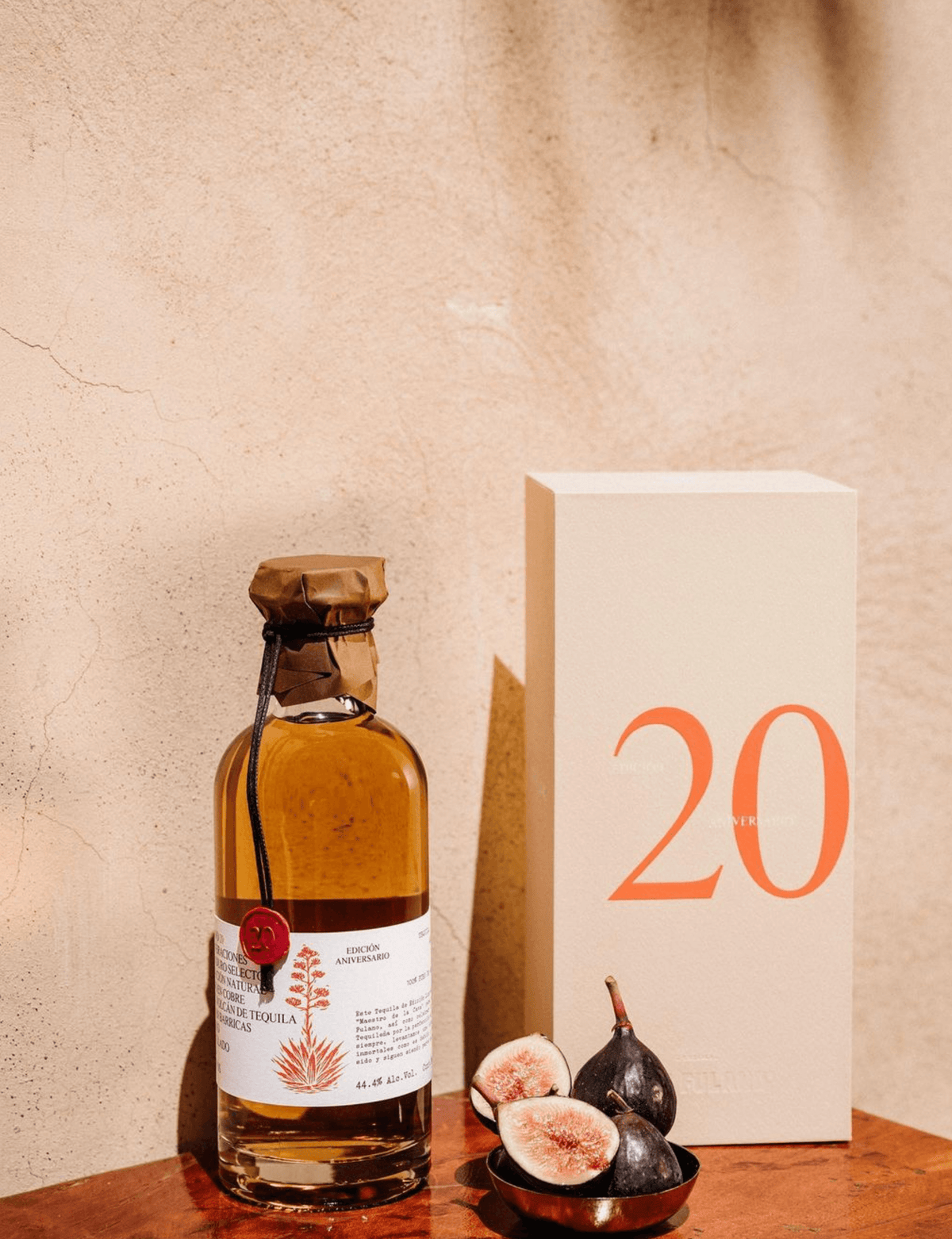 Don Fulano 20th Anniversary Añejo Tequila bottle with elegant packaging and fresh figs, celebrating a special limited release.
