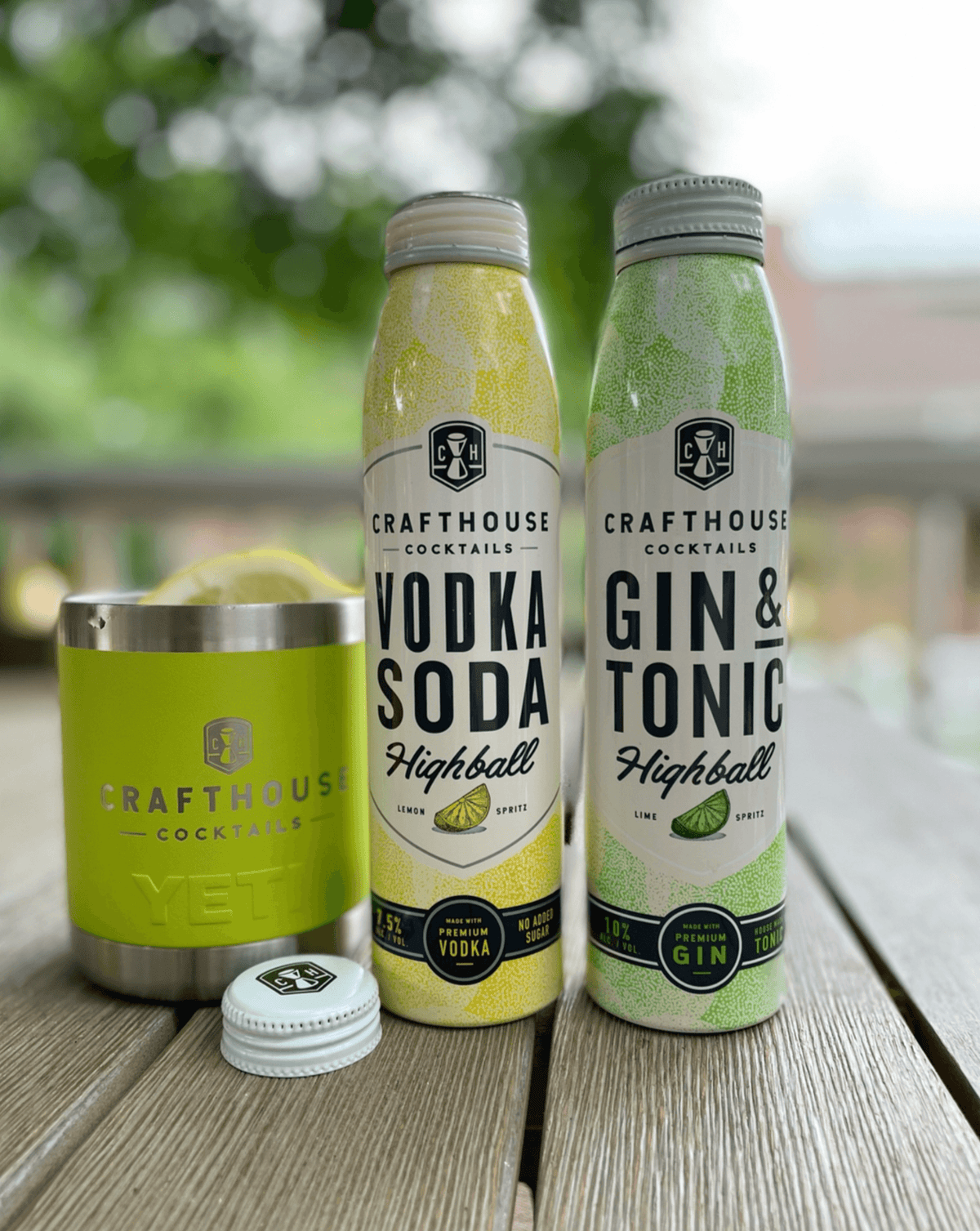 Crafthouse Cocktails Vodka Soda and Gin & Tonic highball cans with YETI tumbler outdoors.