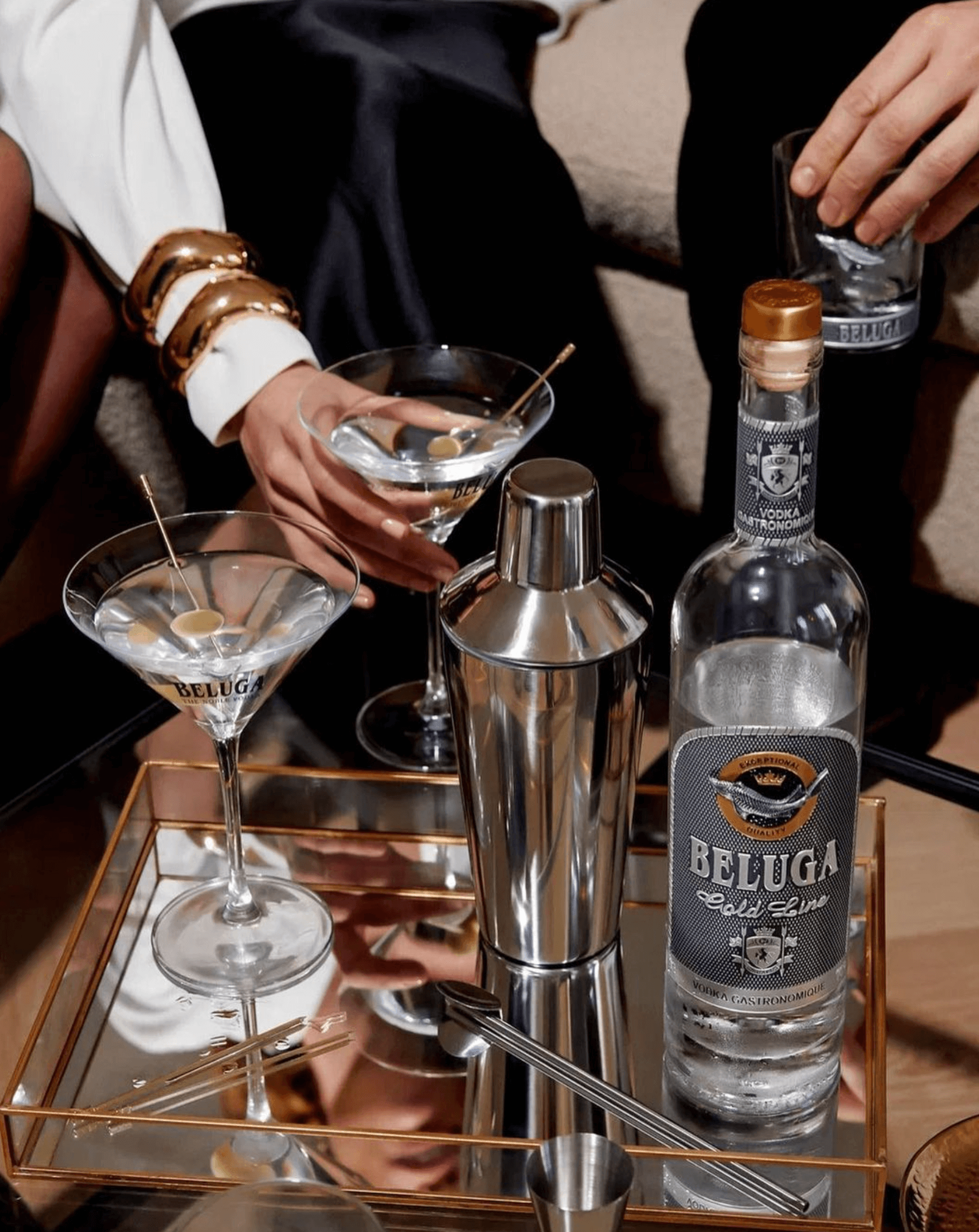 Beluga Gold Line Russian Vodka 750ml on a stylish tray with cocktails, showcasing luxury and fine spirits.