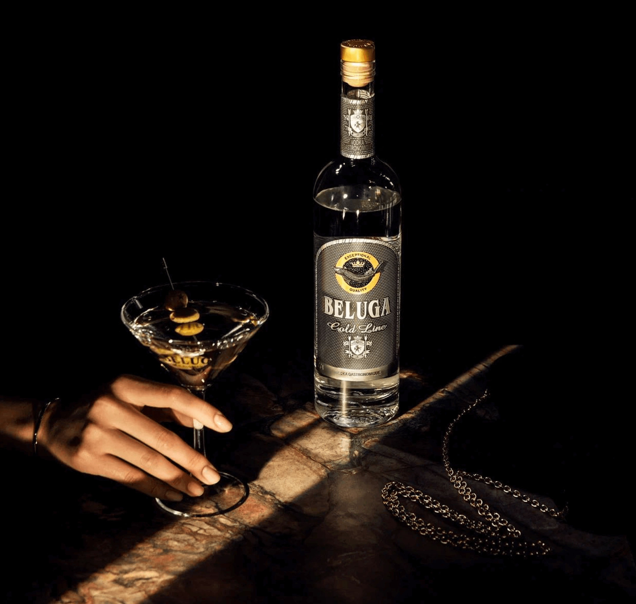 Beluga Gold Line Russian Vodka 750ml alongside a classic martini in dim lighting, showcasing elegance and authenticity.