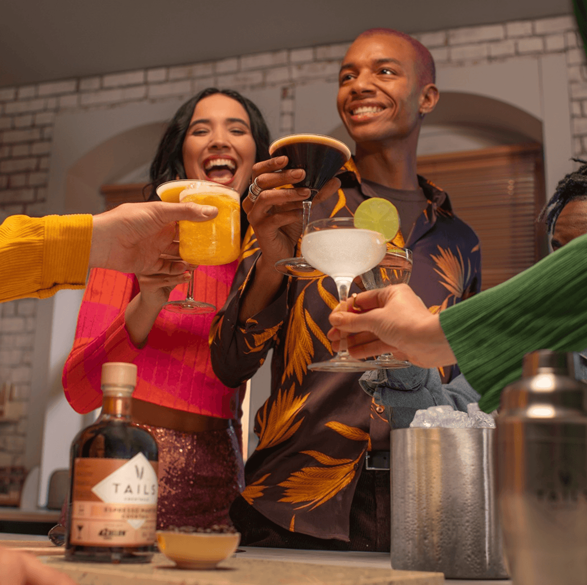 Group of friends enjoying cocktails, including Tails Espresso Martini, in a vibrant setting.
