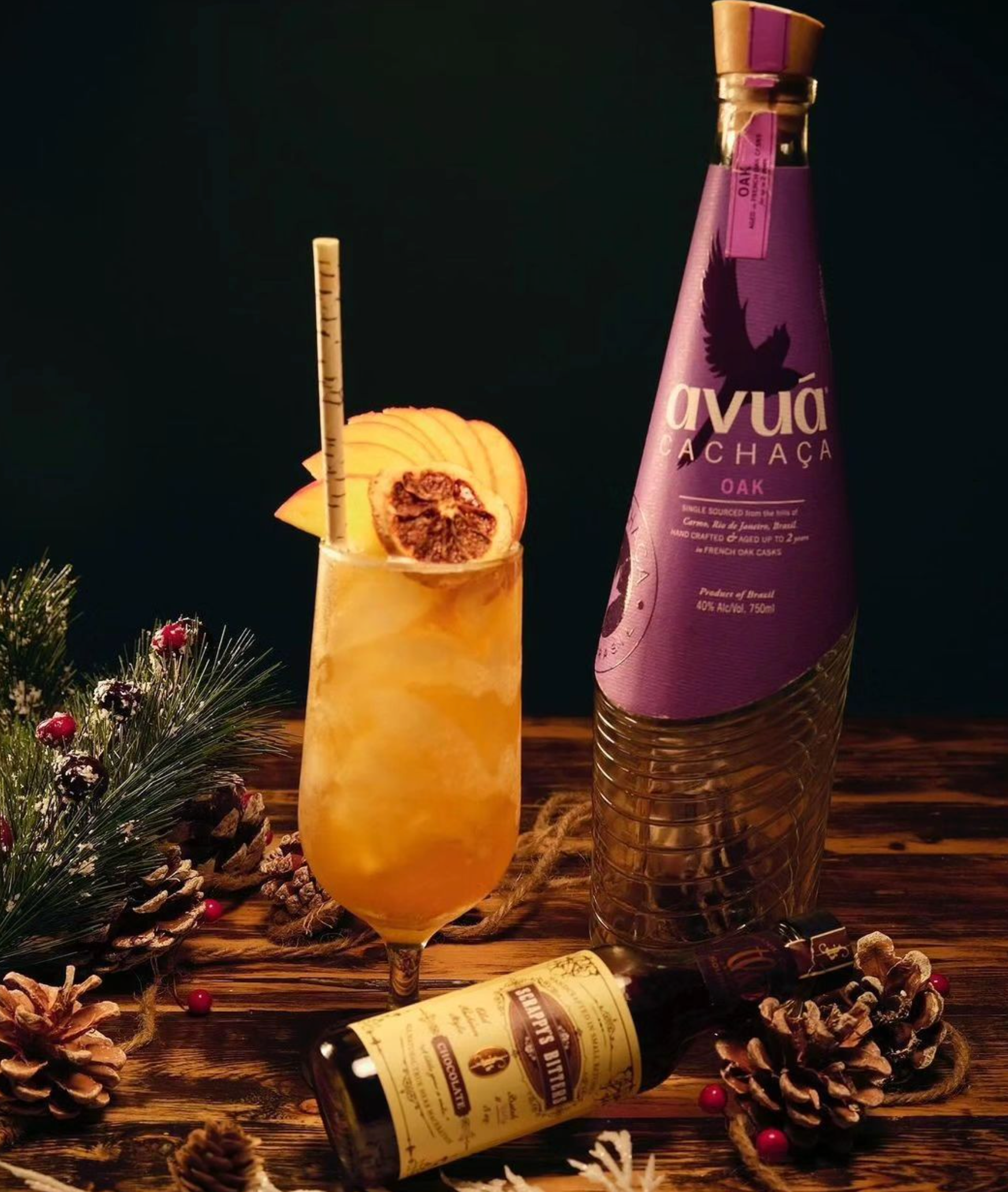 Avuá Oak Cachaça cocktail with garnish, showcasing a bottle and a festive setting.
