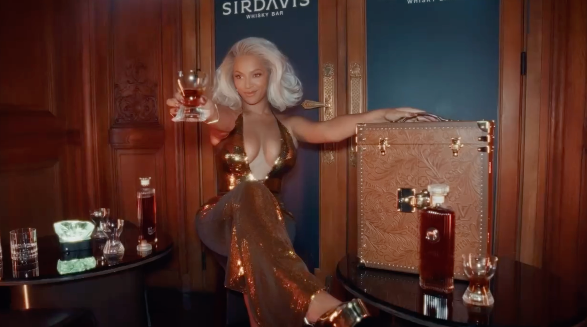 Beyoncé celebrating with a glass of SirDavis whisky in an elegant setting, showcasing luxury and sophistication.