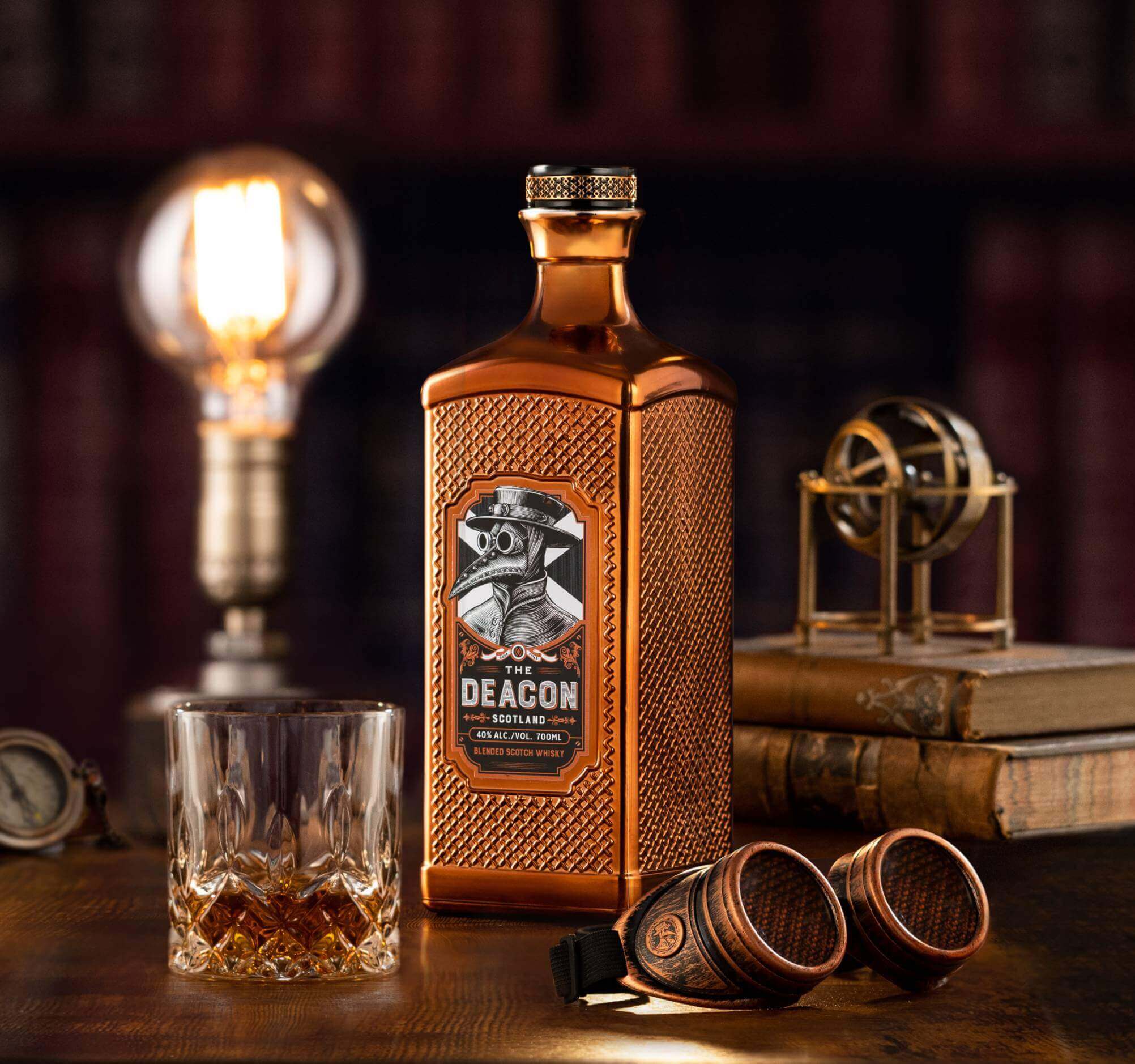 The Deacon Scotland Blended Scotch Whisky bottle with glass, warmly lit, showcasing unique design and rich color.