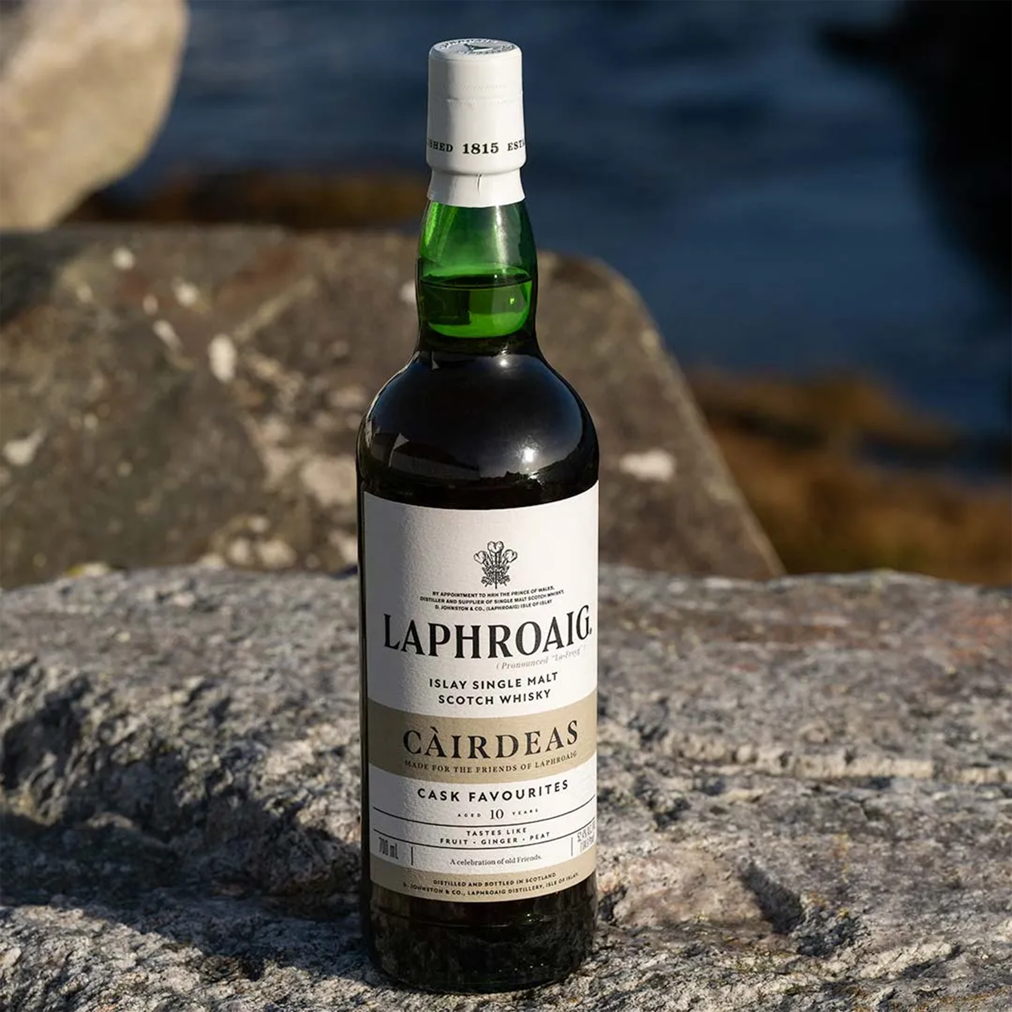 Laphroaig Cairdeas 2024 Cask Favourites Single Malt Scotch bottle on stone background.