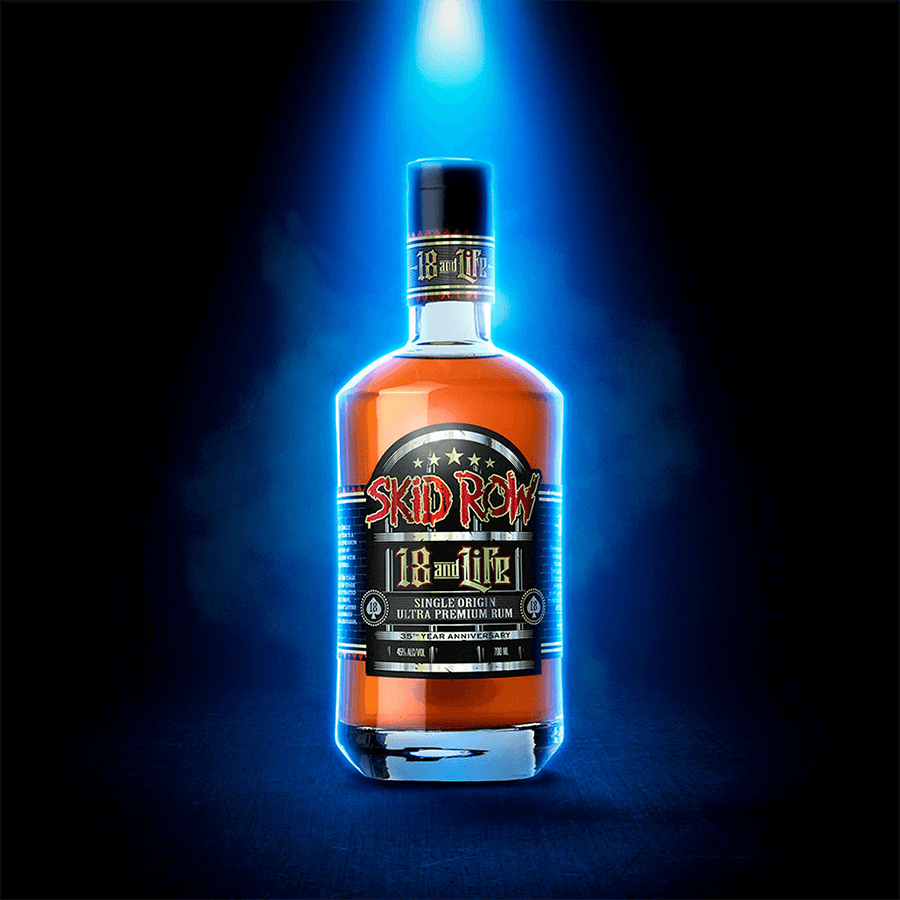 Skid Row 18 and Life Ultra Premium Rum 700ml bottle with blue spotlight on black background.