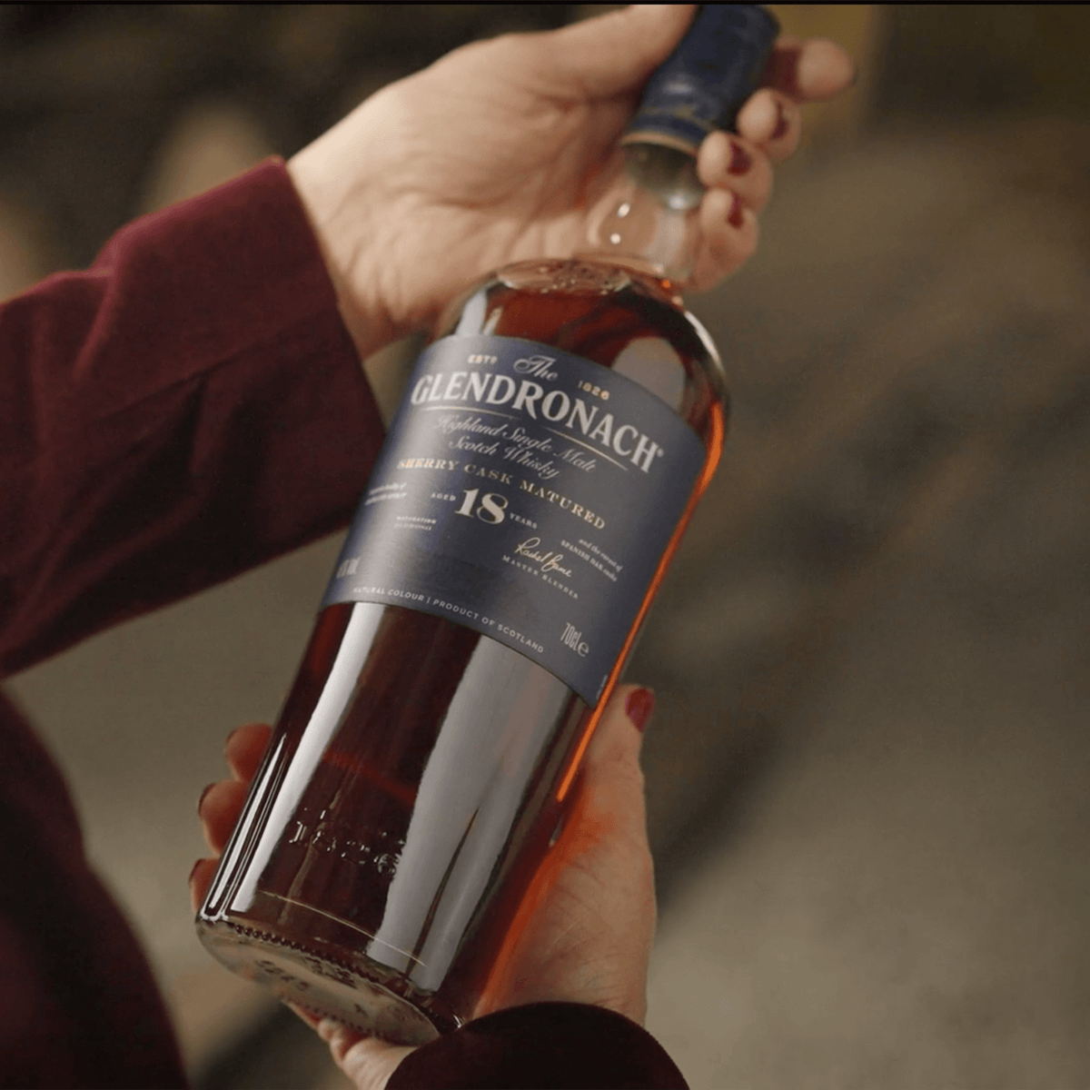 The Glendronach Sherry Cask 18 Year Scotch bottle held in hand, showcasing rich amber color and elegant label.