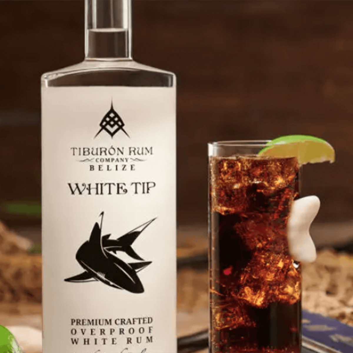 Tiburon White Tip Rum bottle with cocktail; premium, handcrafted, overproof rum from Belize.