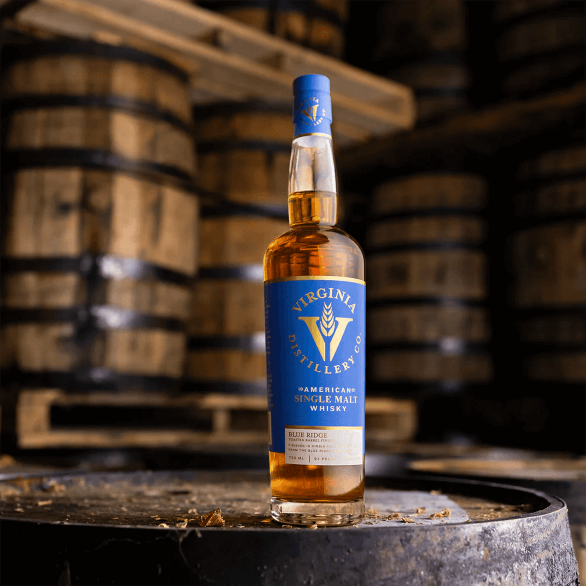 Virginia Distilling Co. Blue Ridge Select Whisky bottle on a barrel, showcasing American single malt craftsmanship.