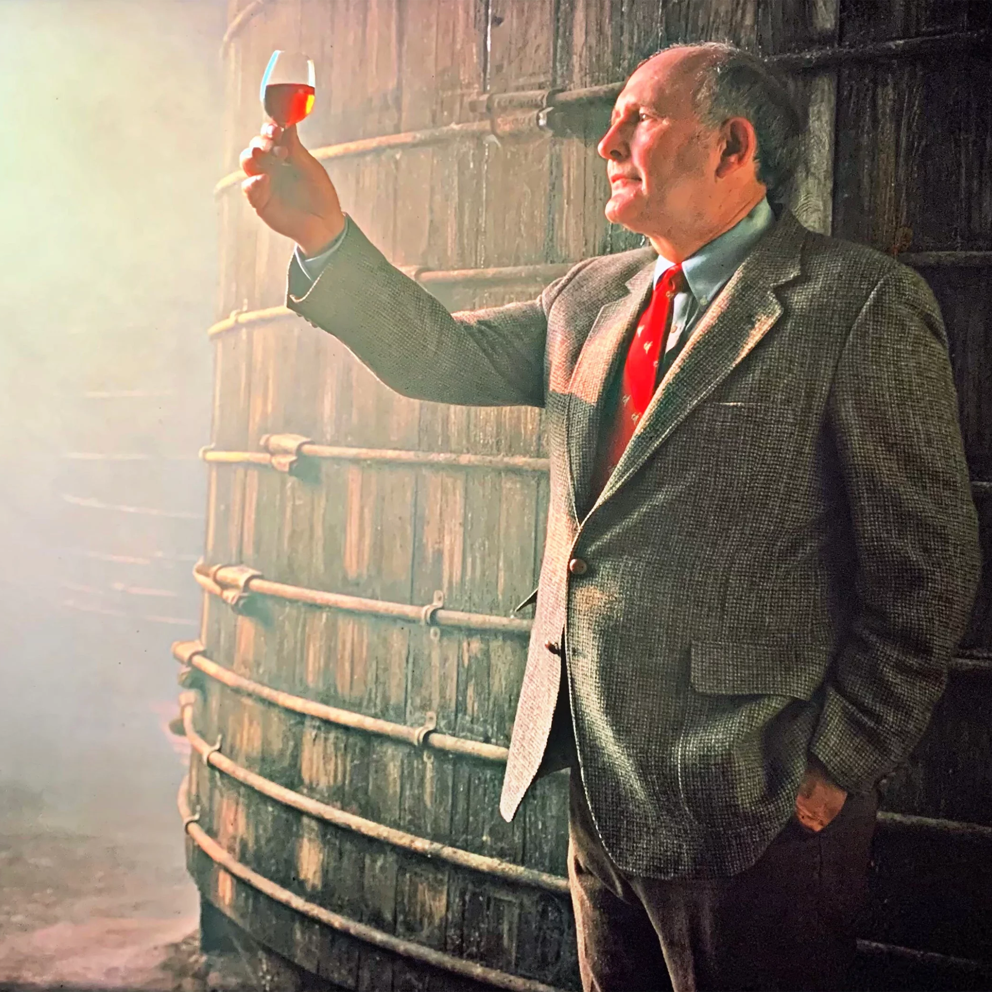 Master Distiller examining Wild Turkey bourbon in a distillery, celebrating craftsmanship and legacy.