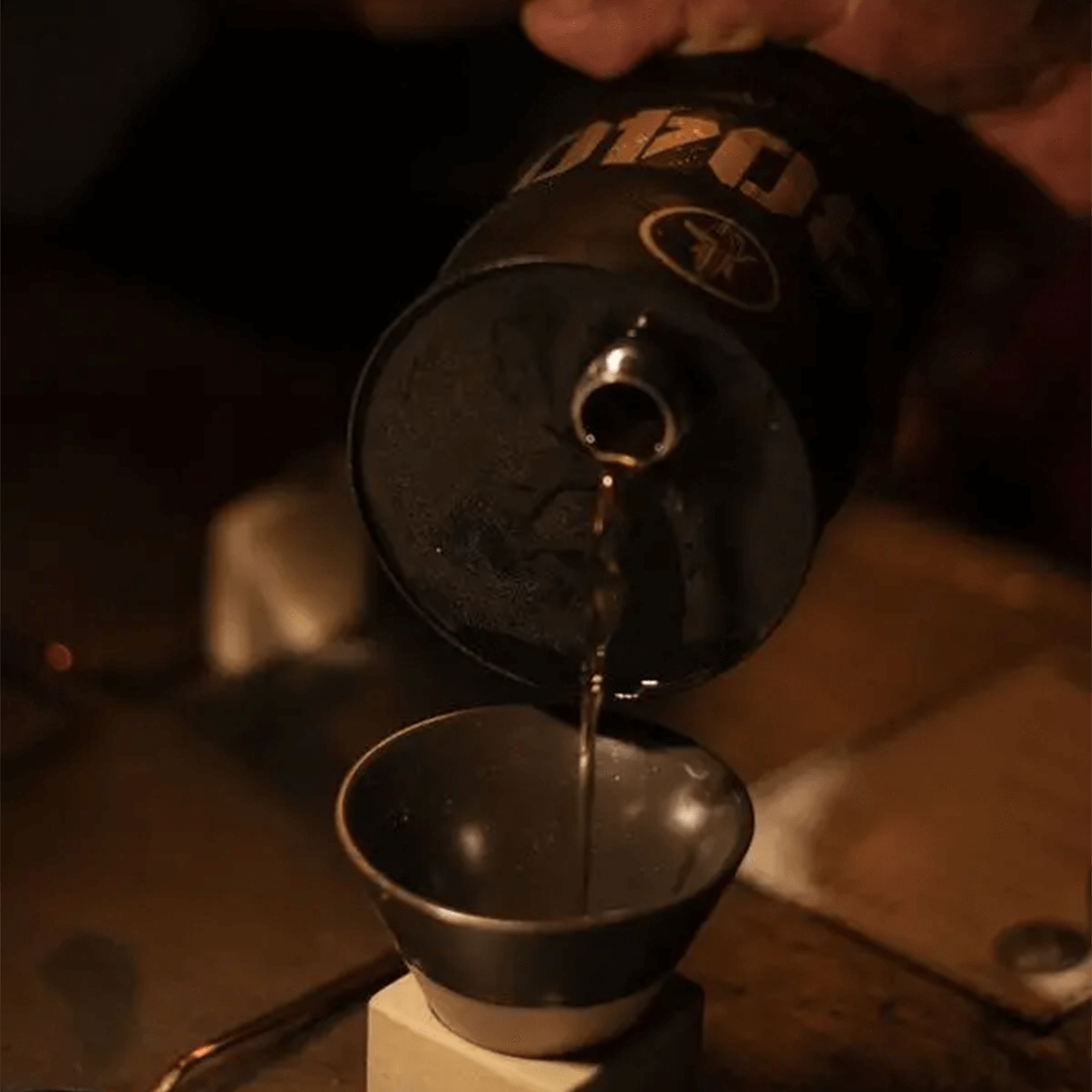 Pouring Whiskey De Maiz 53040 Mexican Whiskey into a measuring cup, highlighting its rich golden color.