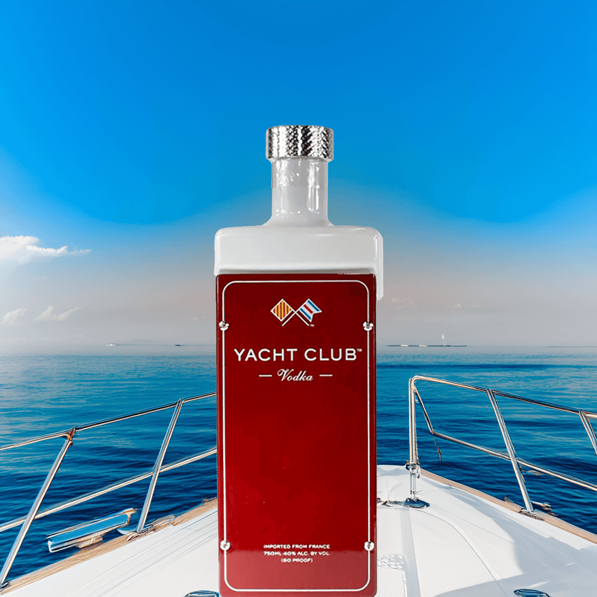 Bottle of Yacht Club Vodka on a yacht with a serene ocean backdrop, symbolizing elegance and sophistication.