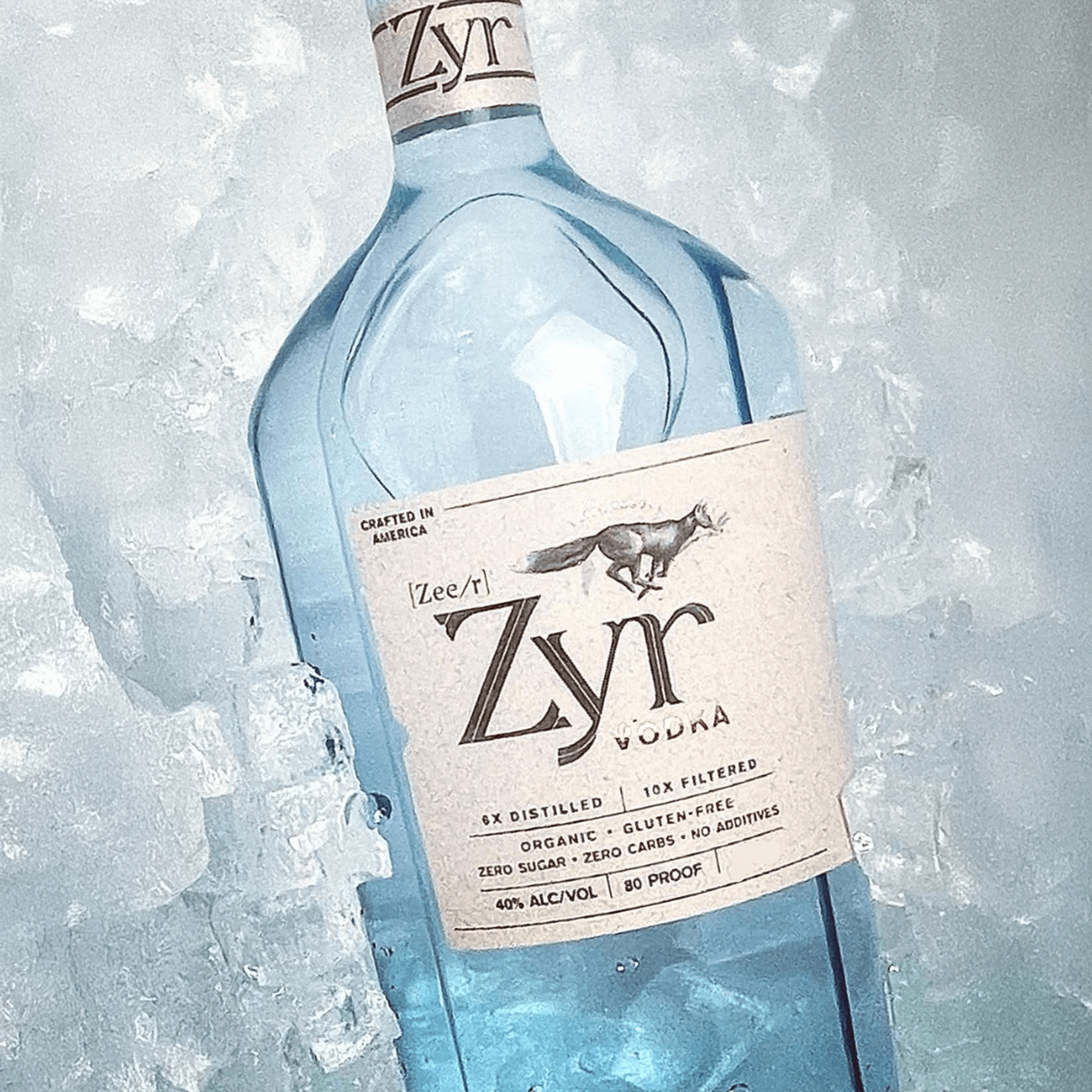 Zyr Organic Vodka bottle on ice, 6x distilled, gluten-free, 80 proof, featuring butterscotch and citrus notes.