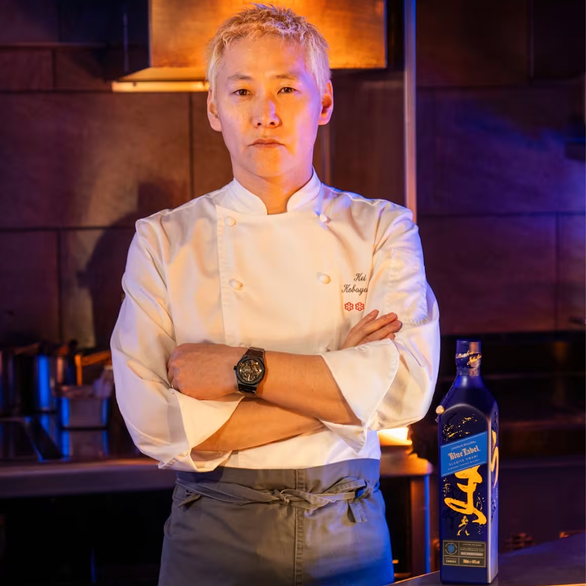 Chef Kei Kobayashi in a kitchen setting with Johnnie Walker Blue Label Umami Scotch.