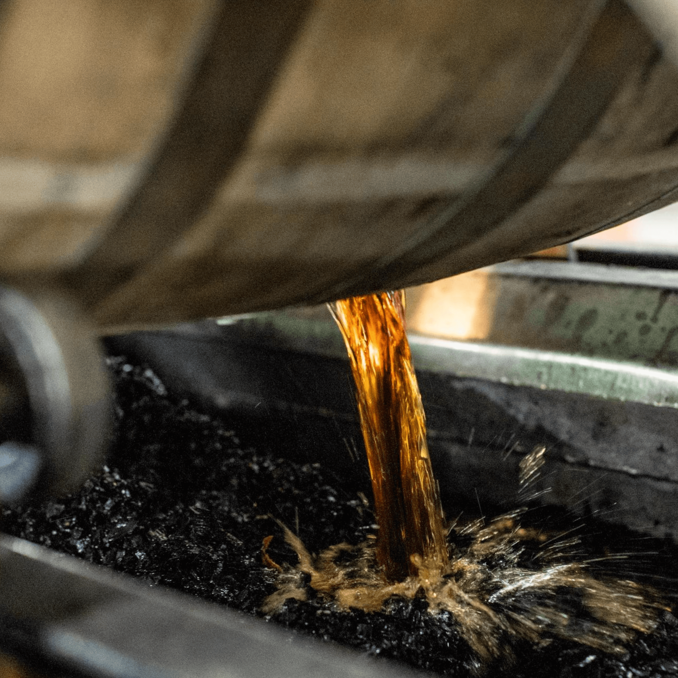 Eagle Rare Bourbon being poured from a barrel into a collector, showcasing its rich amber color.