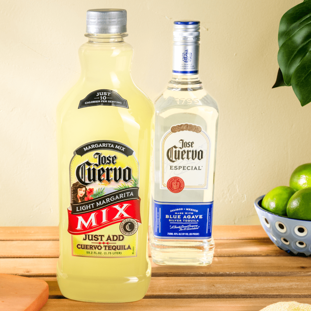 Jose Cuervo Classic Lime Light Margarita Mix bottle next to Cuervo Especial tequila, with limes in the background.