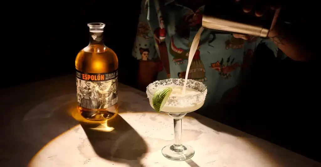Espolón Reposado Tequila being poured into a margarita glass, showcasing its rich golden hue.