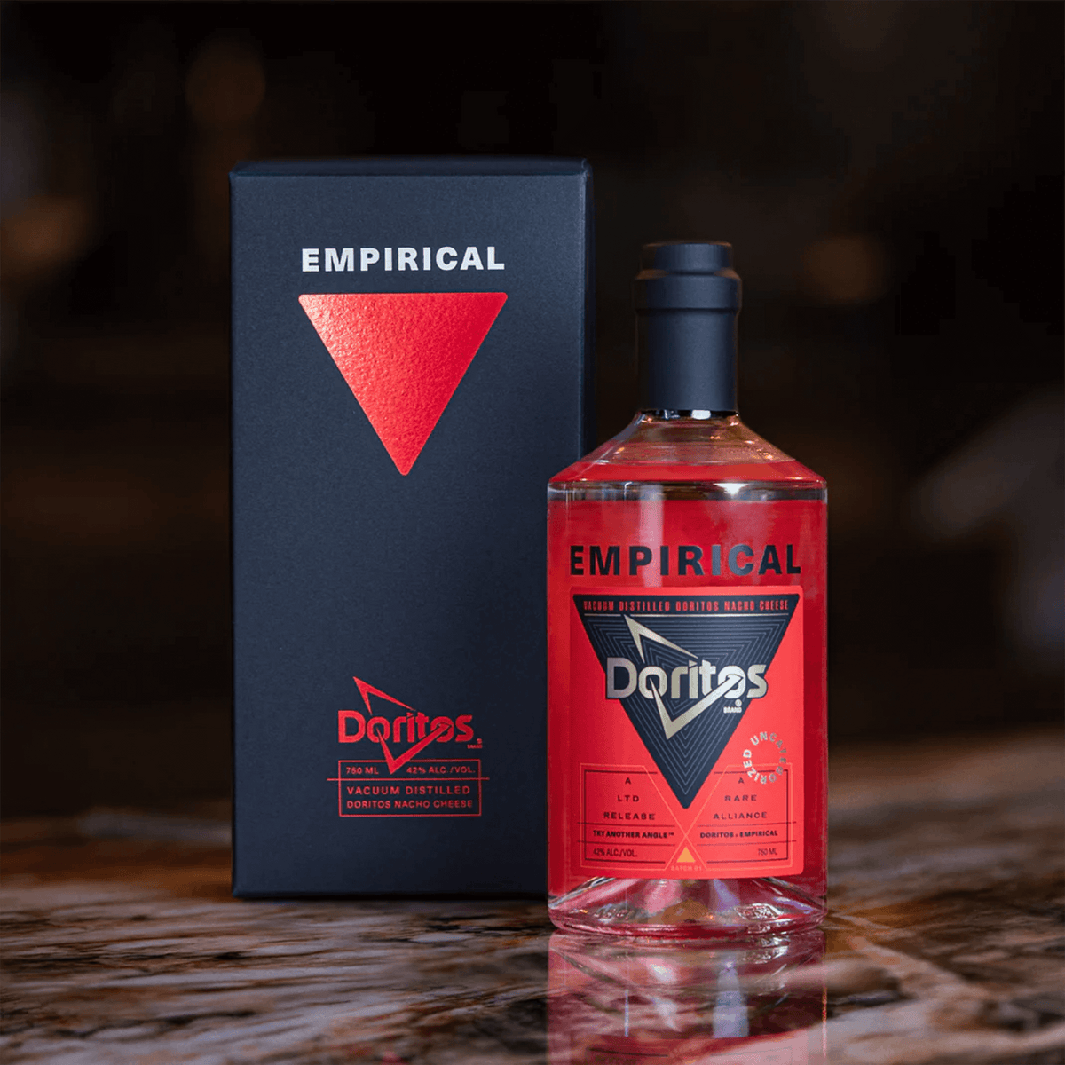 Empirical x Doritos Nacho Cheese Spirit bottle and box, a unique vacuum distilled alcoholic beverage.