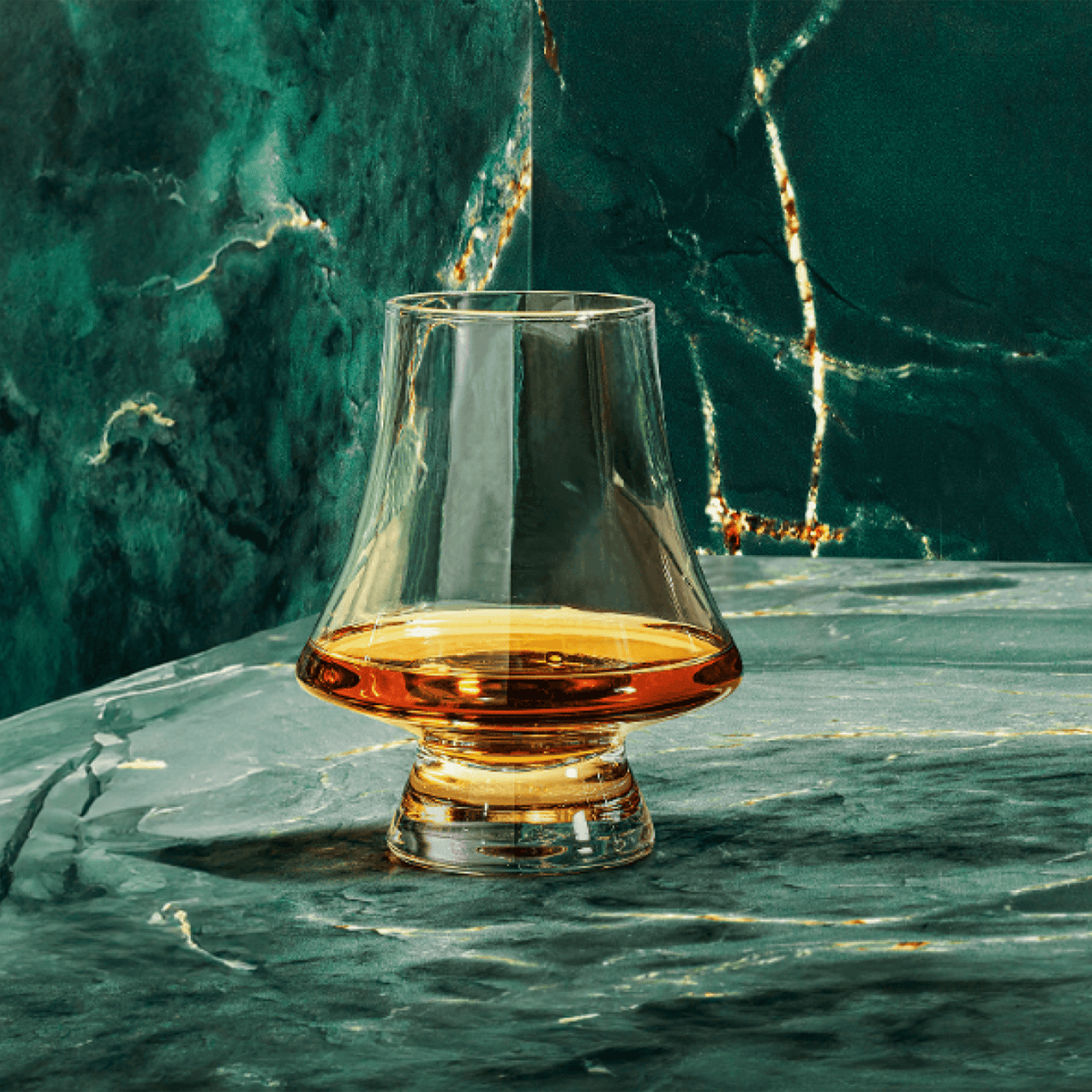Elegant glass filled with Elijah Craig Toasted Rye Whiskey on a marble surface, showcasing rich amber color.