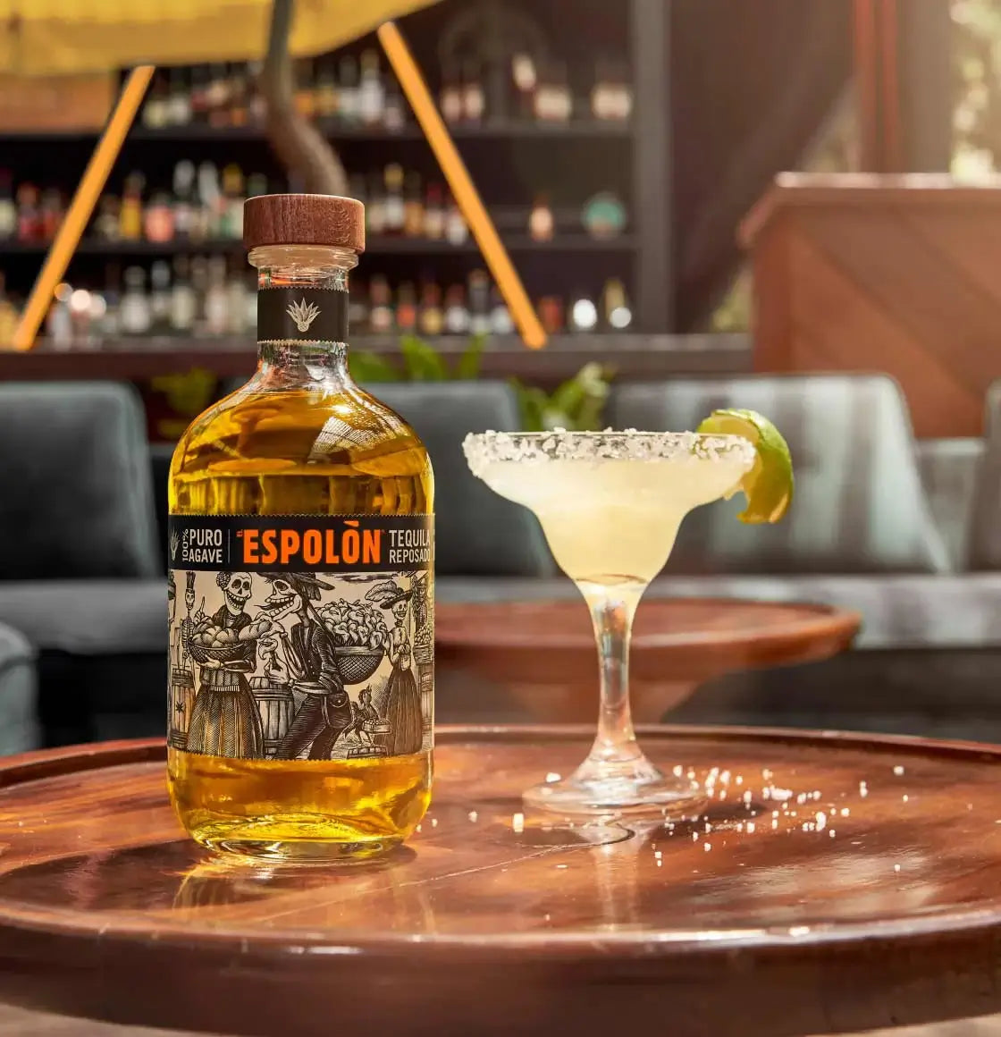 Espolòn Reposado Tequila bottle with margarita glass on a wooden table, perfect for gatherings.