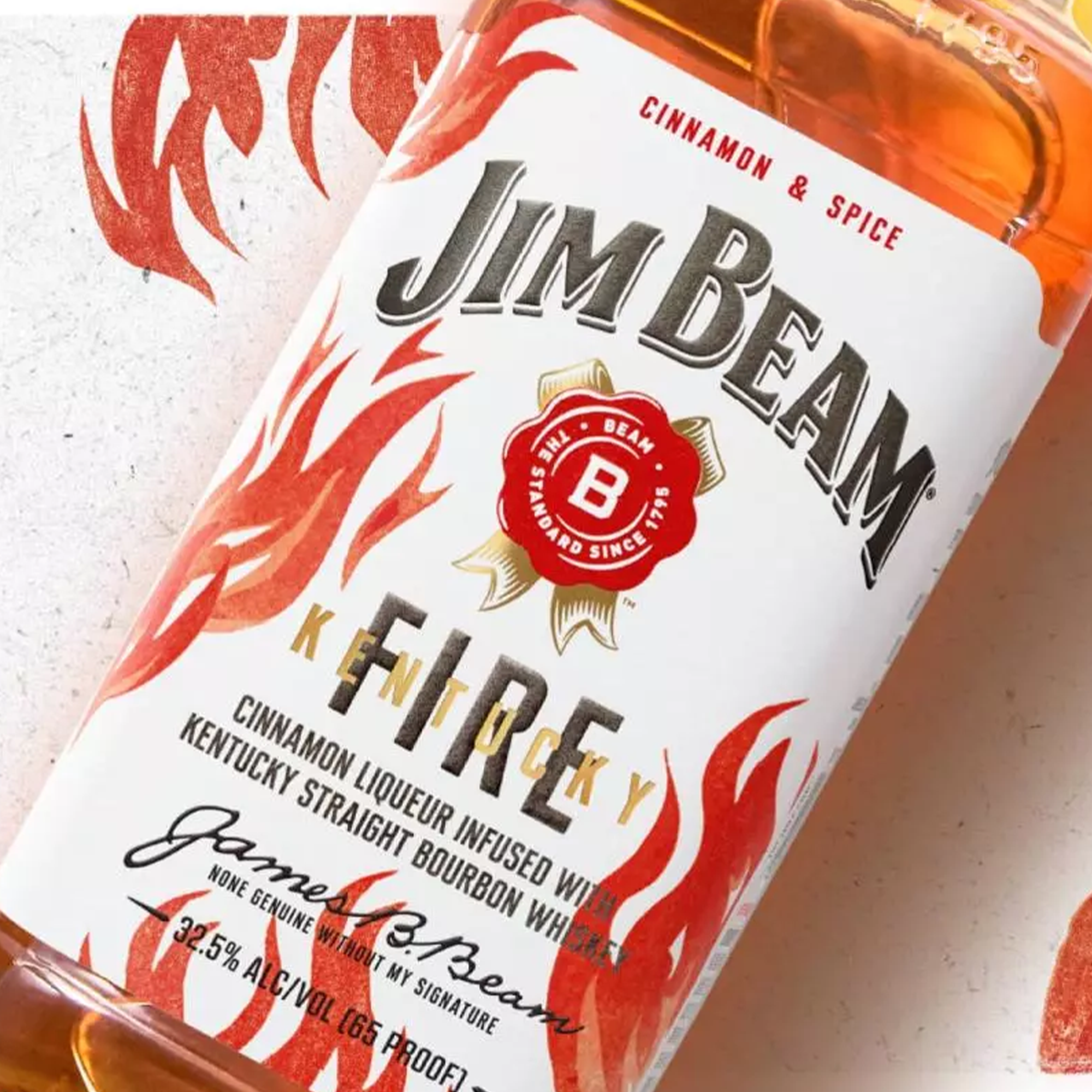 Jim Beam Kentucky Fire Bourbon bottle featuring spicy cinnamon liqueur and bourbon, 1.75L size.