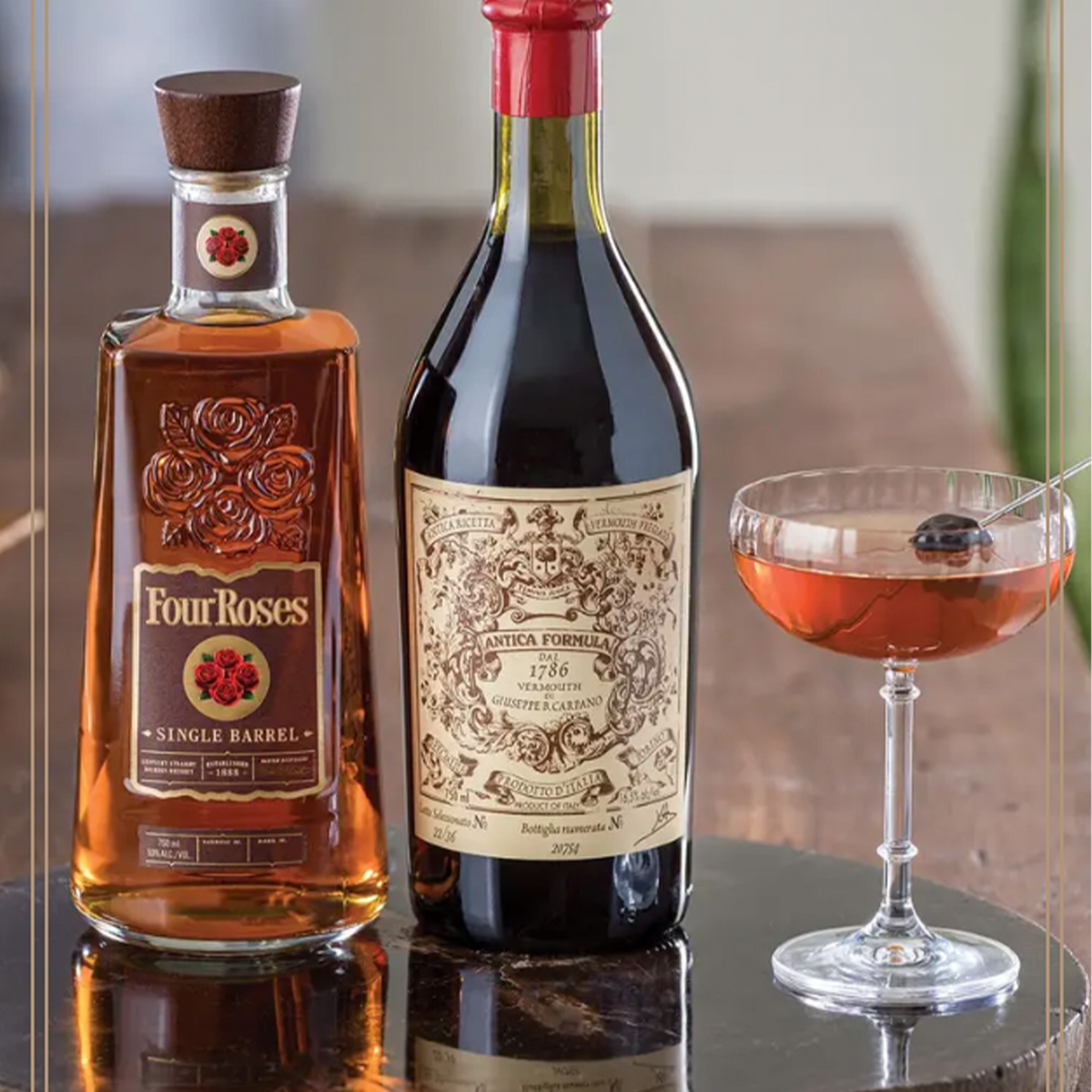 Four Roses Single Barrel bourbon bottle beside Antica Formula vermouth and a cocktail in a glass.