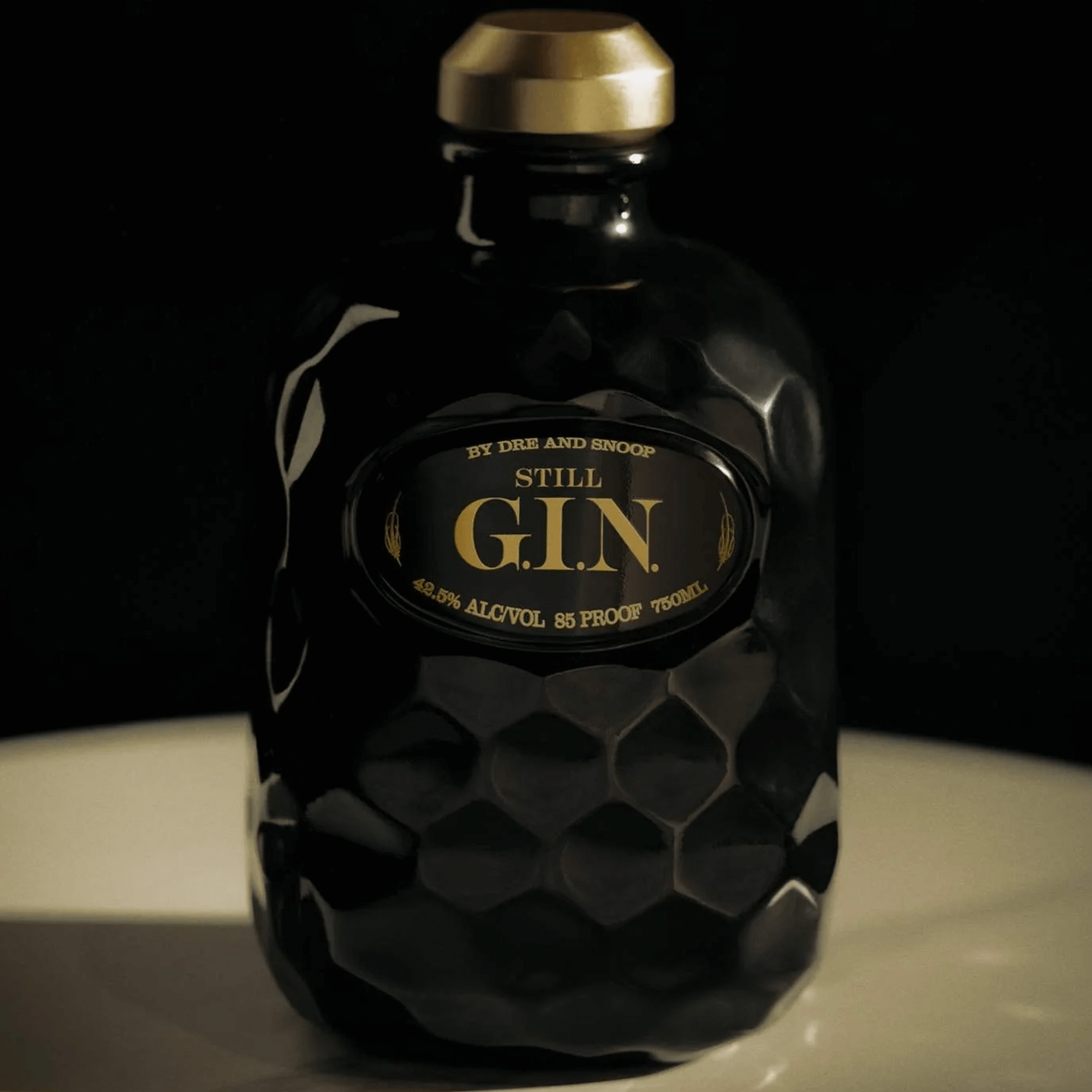 Still G.I.N. by Dre & Snoop gin bottle featuring a sleek black design and gold labeling.
