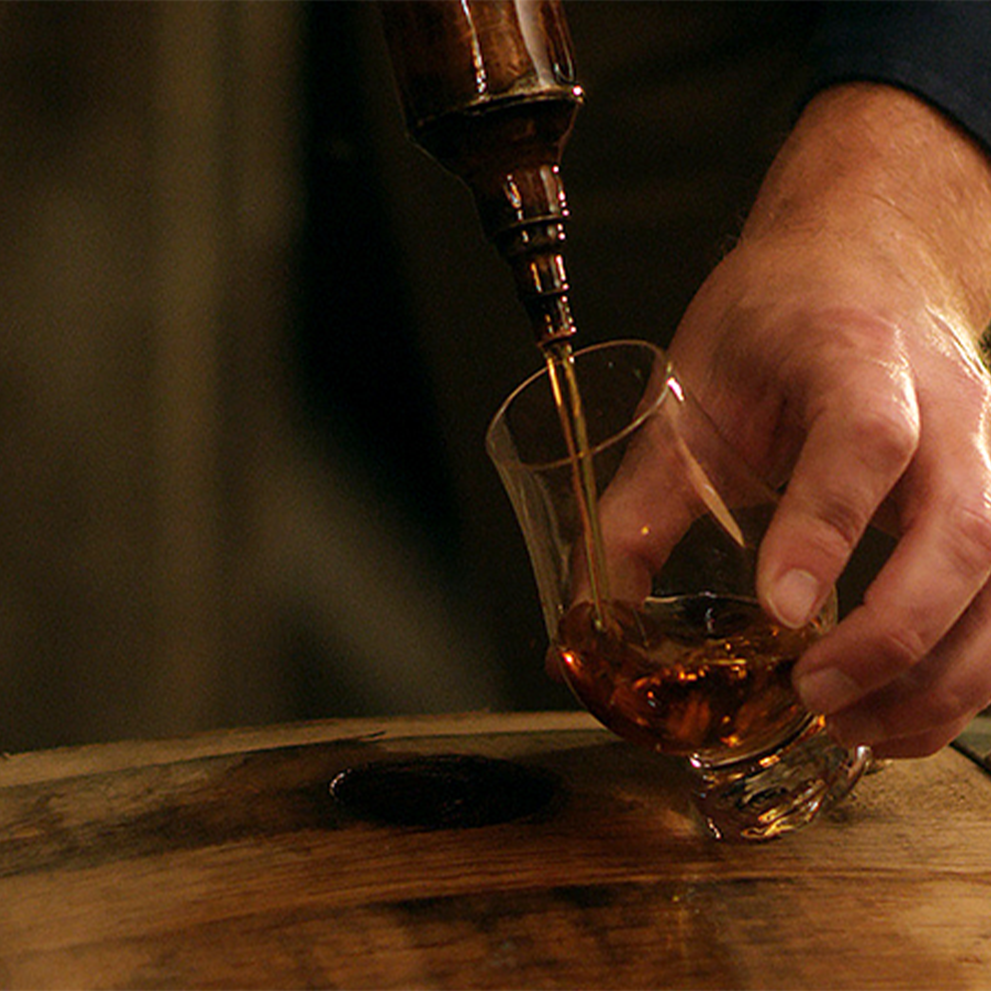 Pouring Heaven Hill Grain to Glass Straight Bourbon from a barrel into a glass.
