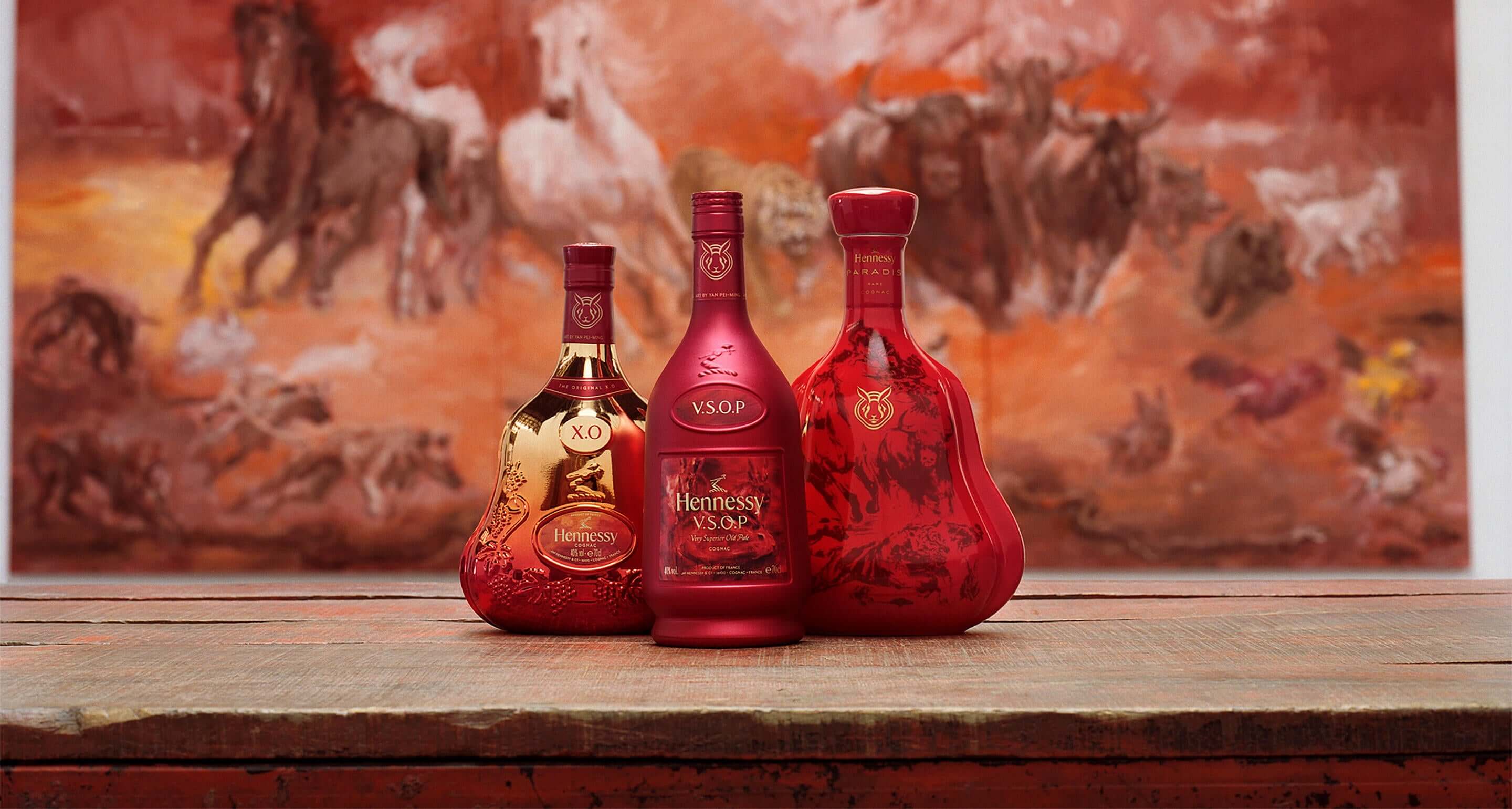 Hennessy VSOP Lunar New Year 2023 limited edition bottles in front of a vibrant painting.