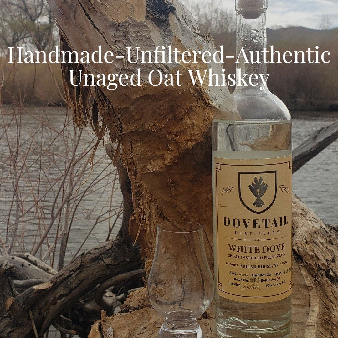 Dovetail Distillery White Dove grain spirit with glass, showcasing its unfiltered and authentic qualities.
