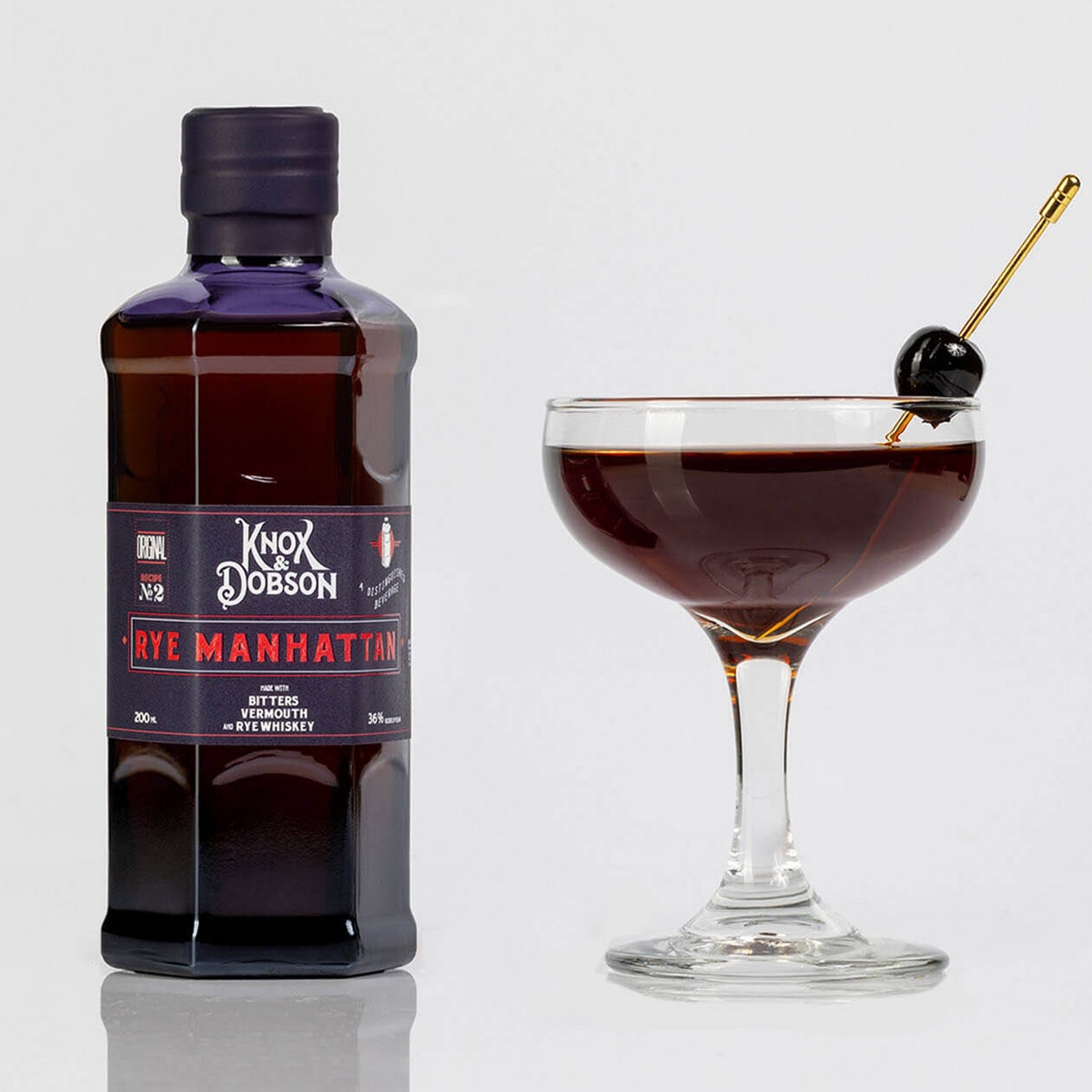Knox & Dobson Rye Manhattan bottled cocktail with glass, featuring aged rye whiskey, sweet vermouth, and bitters.