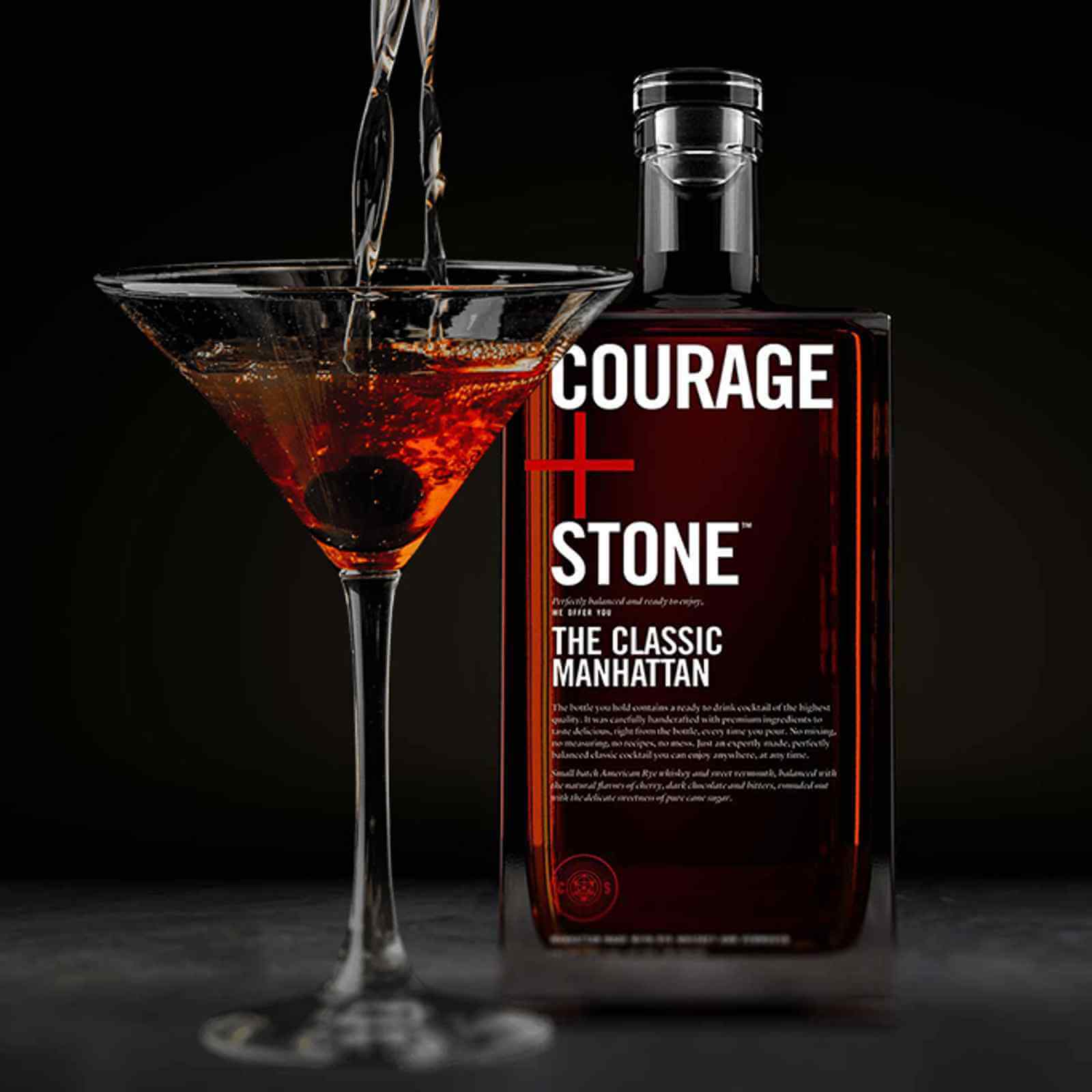 Courage + Stone Classic Manhattan cocktail bottle beside a martini glass filled with the drink, set against a dark background.