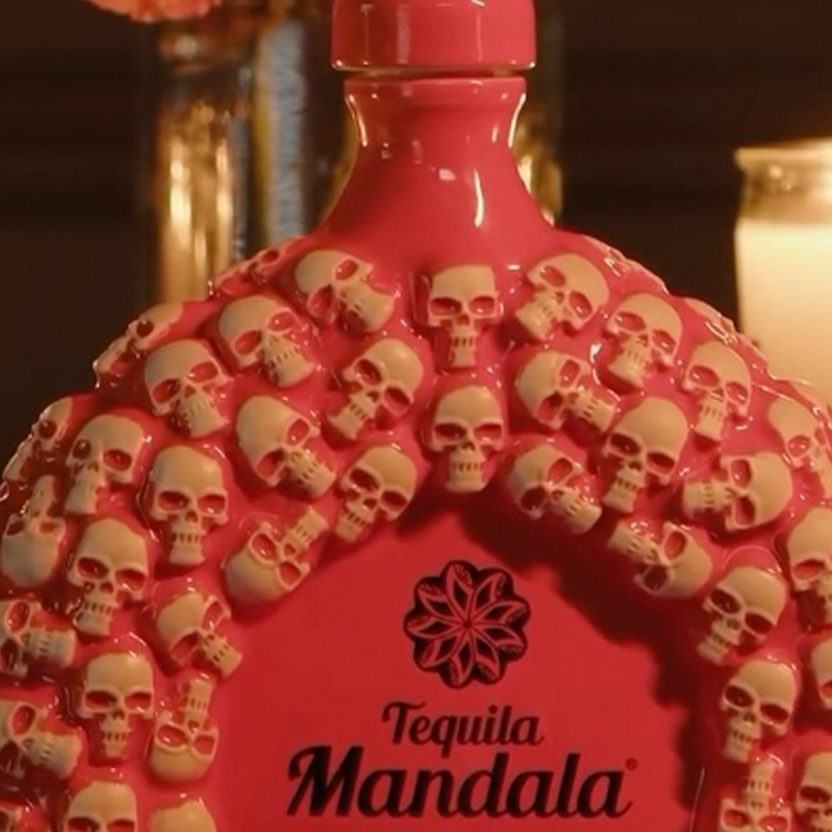 Close-up of Mandala Dia De Los Muertos Añejo Tequila bottle featuring intricate skull designs for collectors.