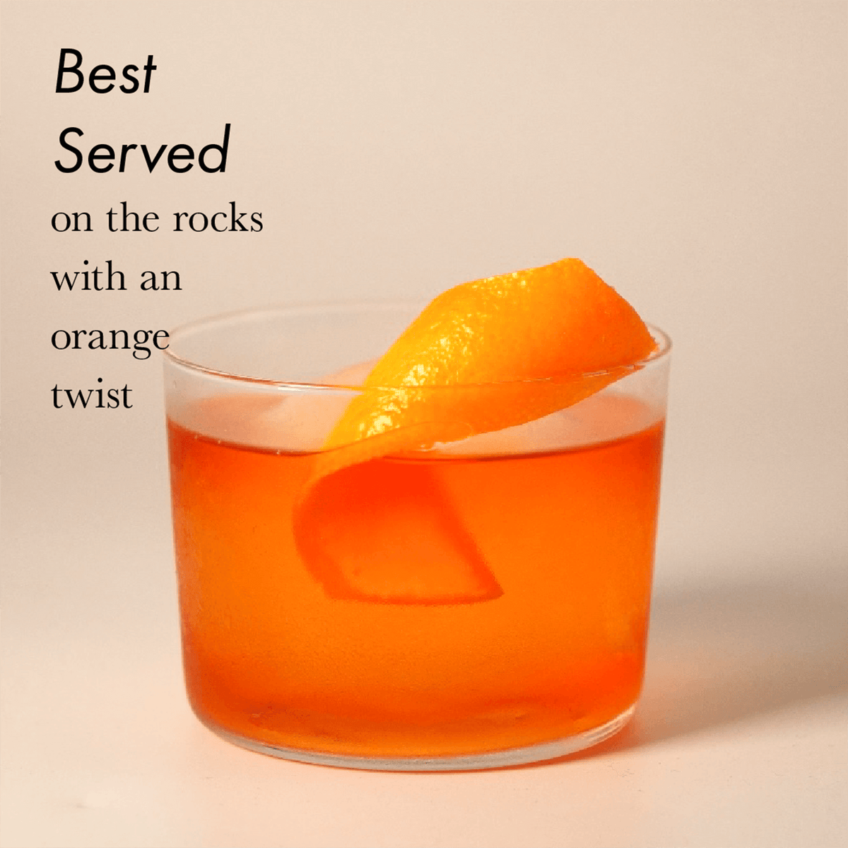 Freitag Negroni served on the rocks with an orange twist in a glass, showcasing its vibrant color.