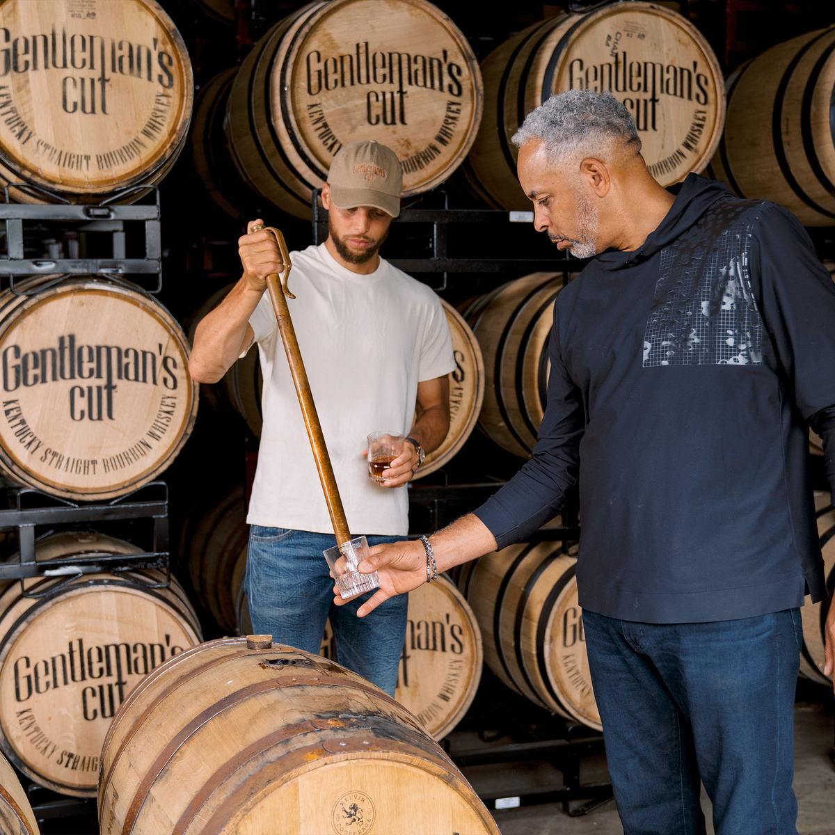 Father and son at the distillery inspecting barrels of Gentleman's Cut bourbon.